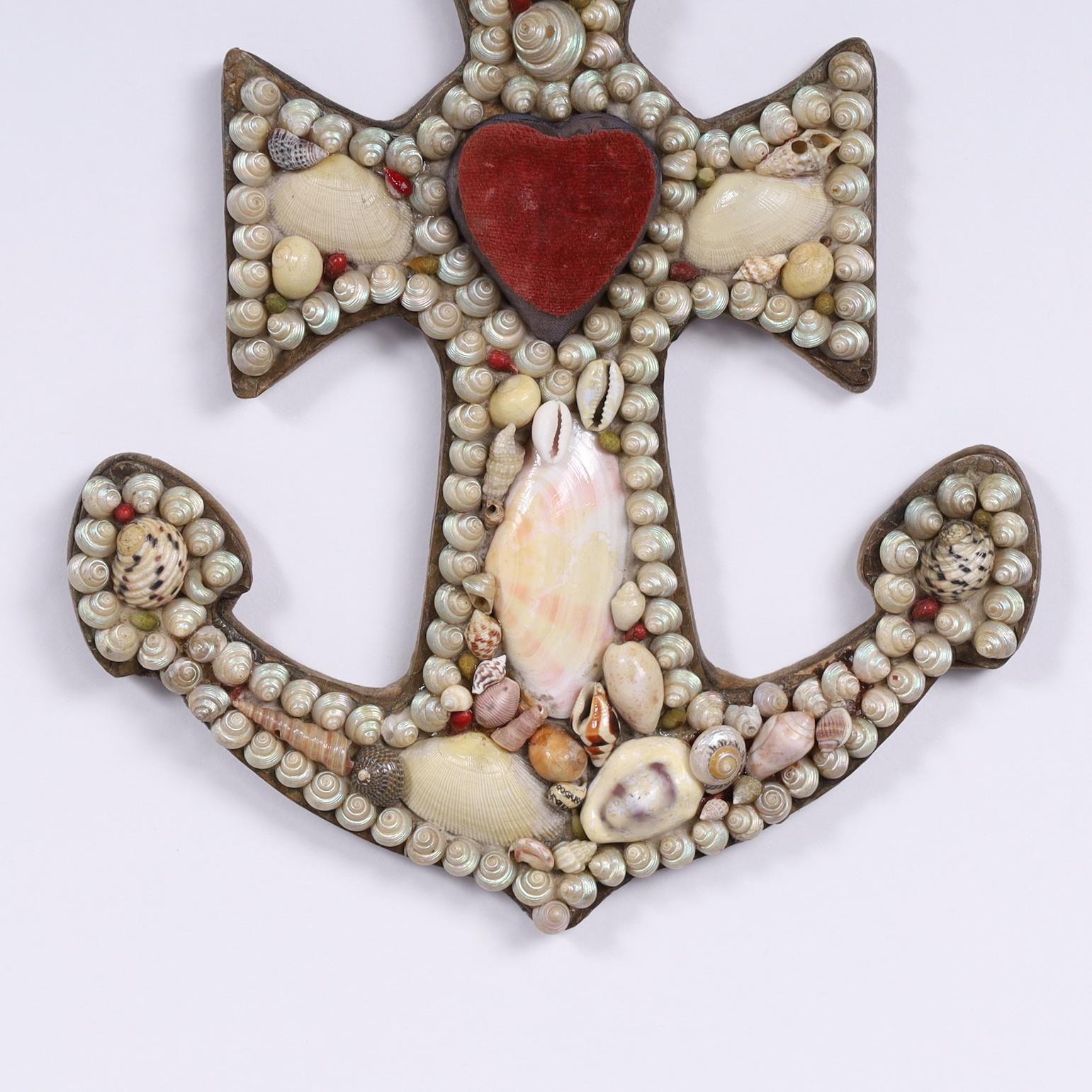 Antique sailors valentines from the West Indies in an unusual anchor form, hand decorated in exotic seashells and featuring pincushions, giving function to form. 