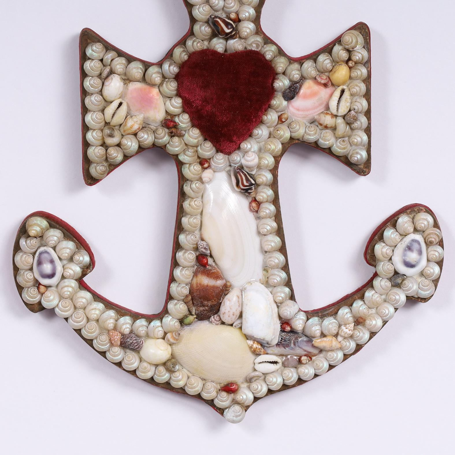 Antique sailors valentine from the West Indies in an unusual anchor form, hand decorated in exotic seashells and featuring pincushions, giving function to form. 