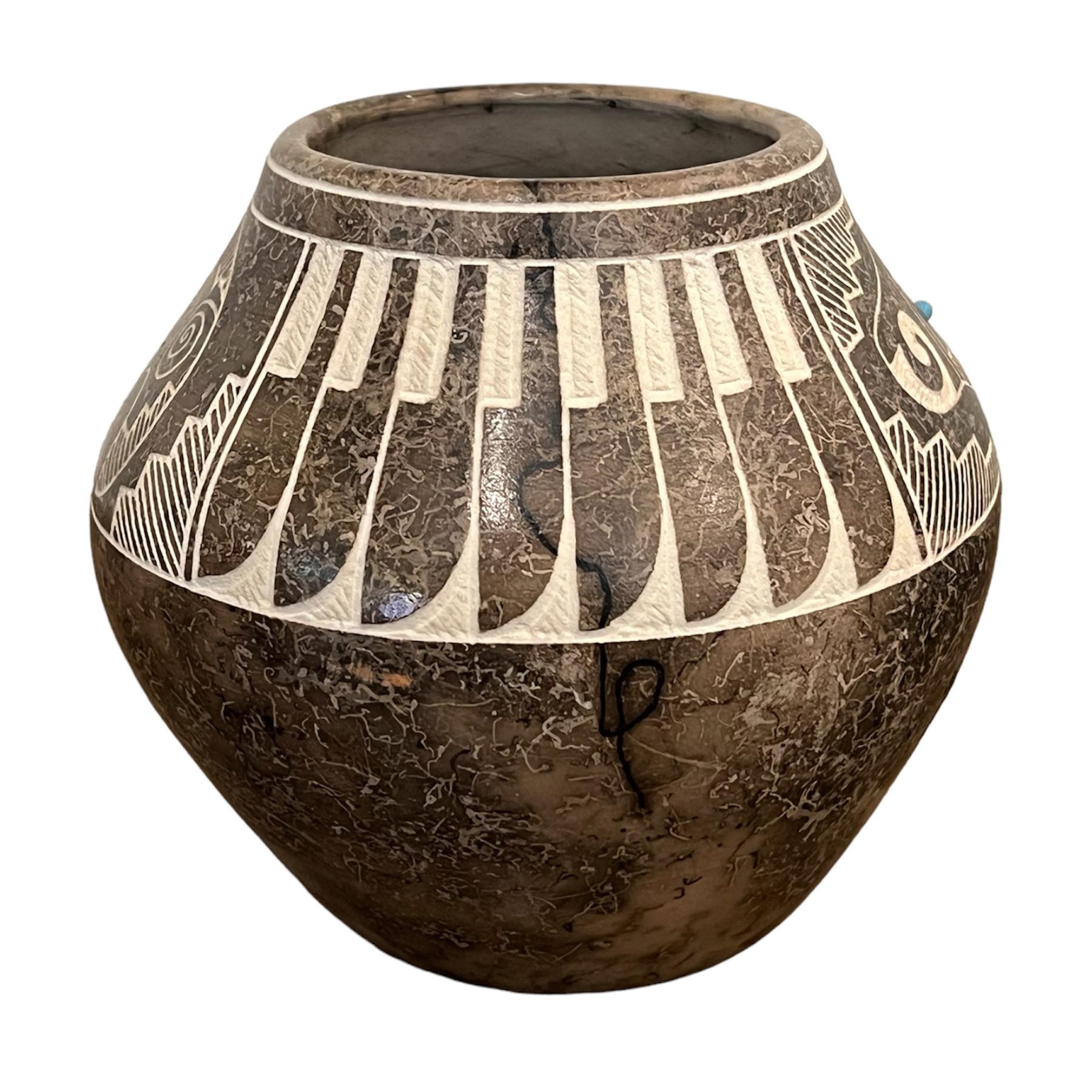Gary Louis and his wife, Corrine, are Acoma potters. Corrine is a third generation potter from the Marie Z. Chino family. Corrine and Gary are carrying on the family tradition of working with pottery. They first came across the idea of using human