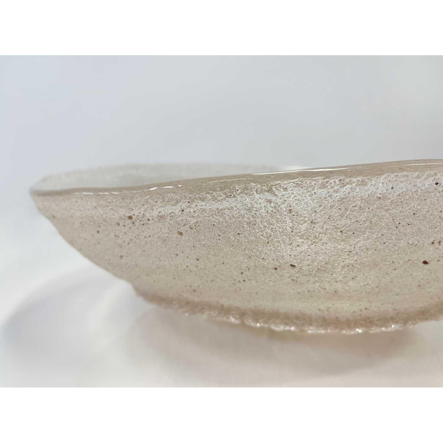 Andrew Beauchamp is a Canadian glass artist and technician. He has worked as a teaching assistant, a production glassblower, a gallery installer and as an assistant to many well-known Canadian glass artists.
 
His series of sandcast bowls were