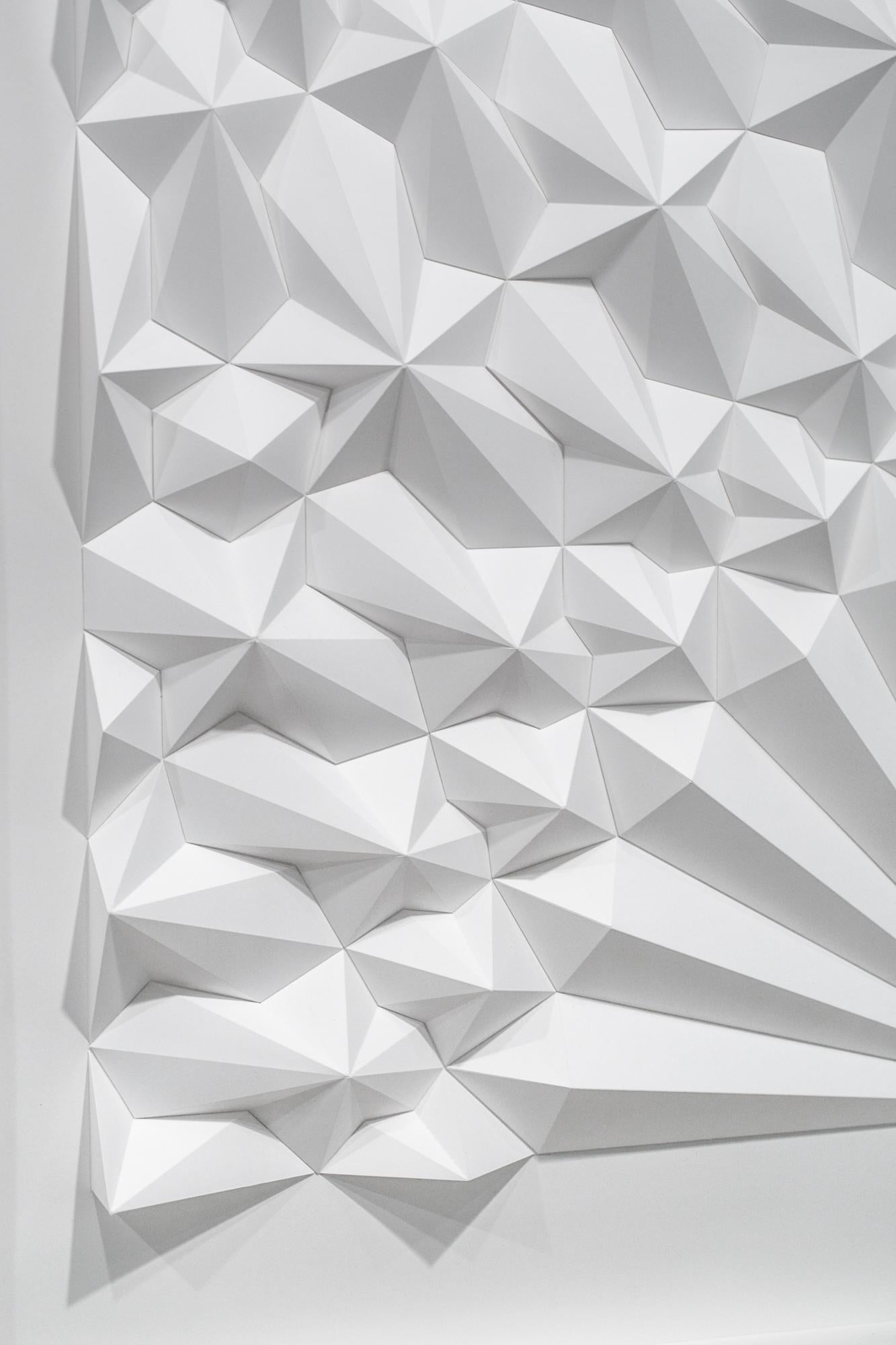 This white geometric, abstract, wall-hanging sculpture titled 