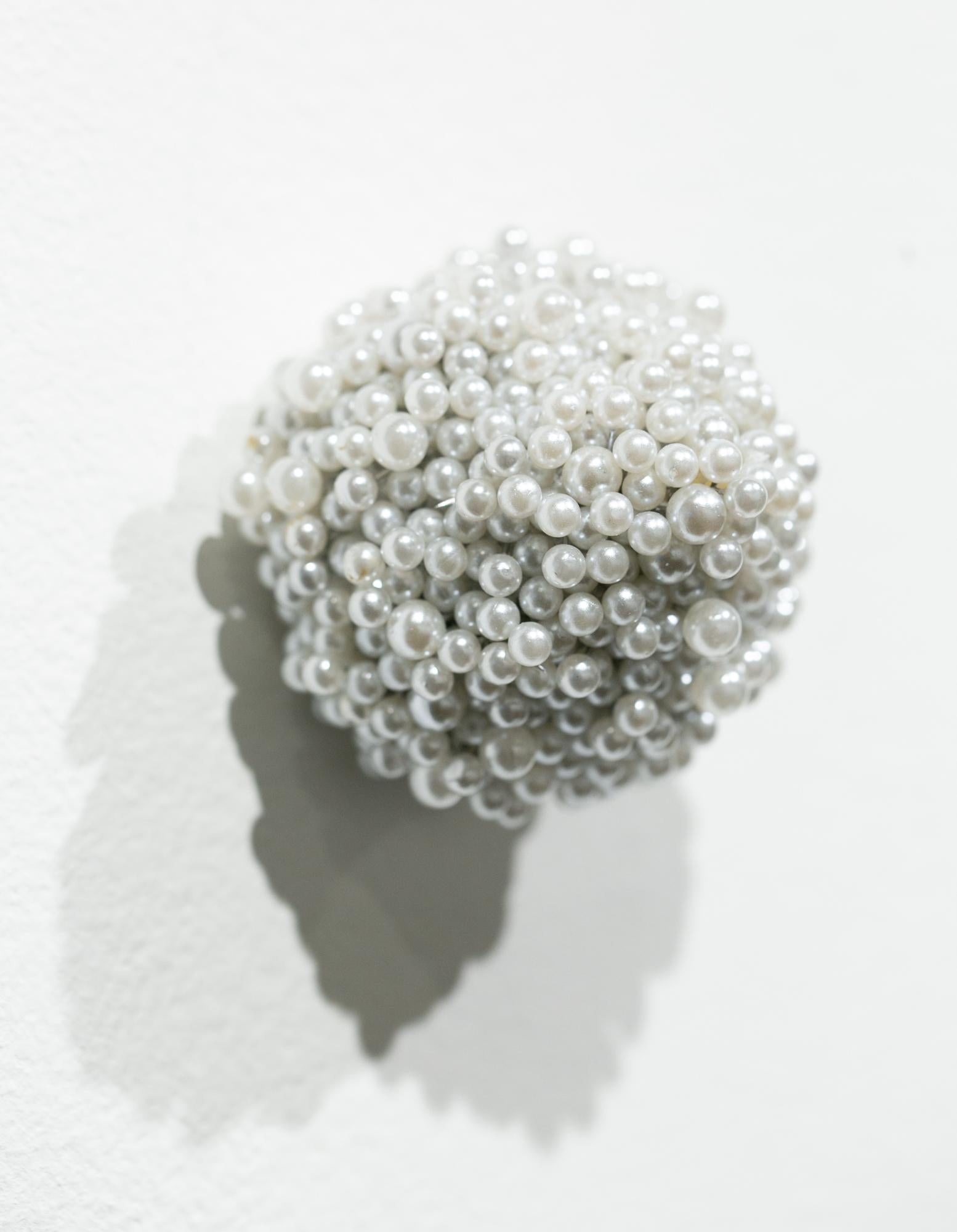 This abstract sculpture titled "Tickler #5" is an original artwork by Angela Ellsworth made of pearl corsage pins, brass, and industrial foam. This piece measures 2.5”h x 2.25”w x 2”d.

Angela Ellsworth is a multidisciplinary artist traversing