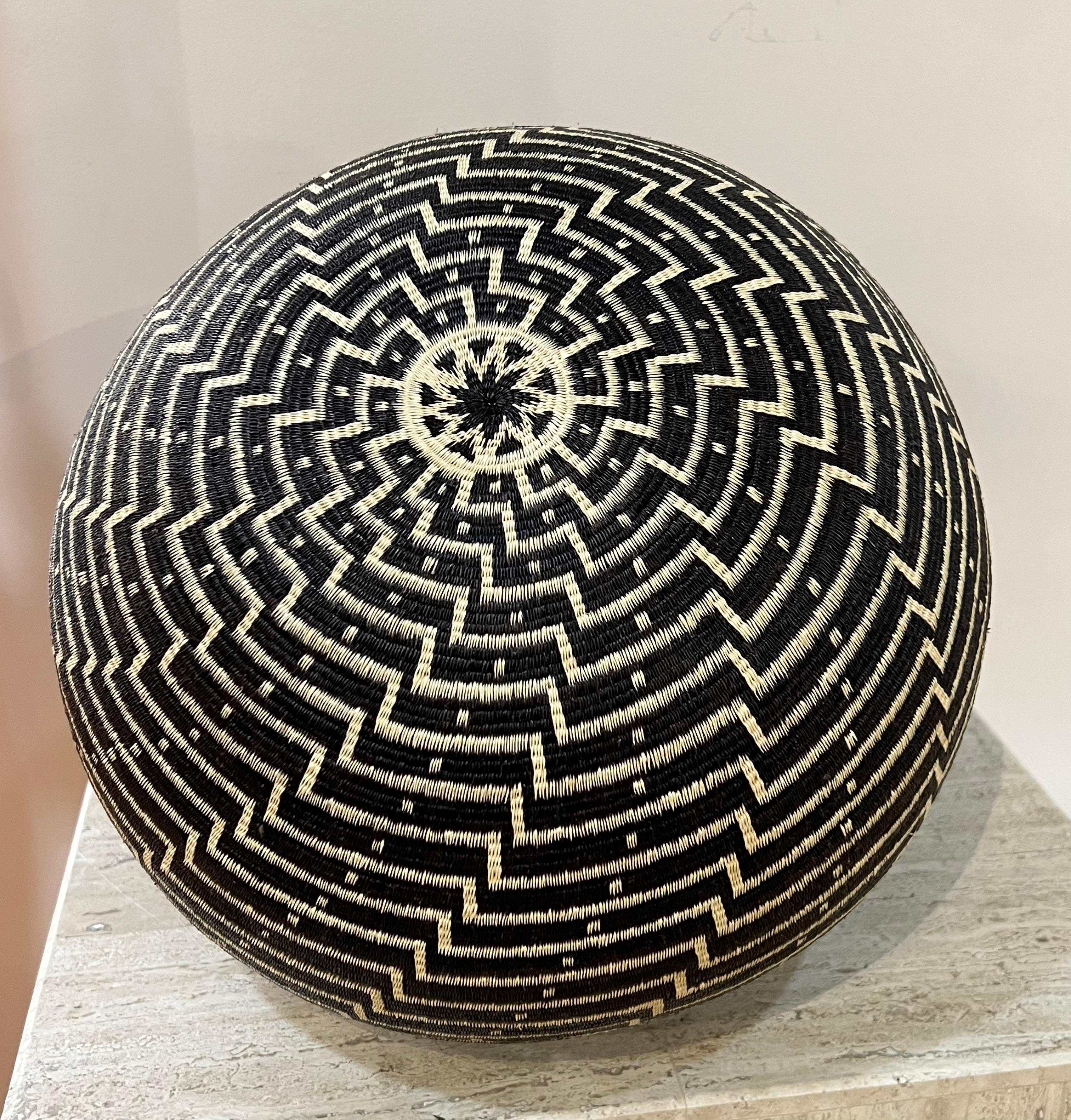 Black and White Basket, Wounaan Tribe, Panama, Rainforest, Geometric, round

The baskets are made by the Wounaan and Embera Indians from the Darien Rainforest in Panama.  The Wounaan believe they emerged from the palm tree. They weave baskets from