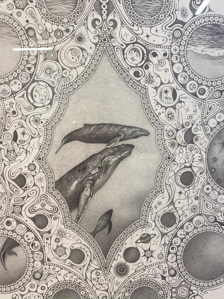 A meticulously rendered trio of whales, a mother whale and its two children, are at the center of this drawing and the prominent feature of this mandala. Many cultures associate whales with compassion, spiritual awareness, wisdom and good luck, a