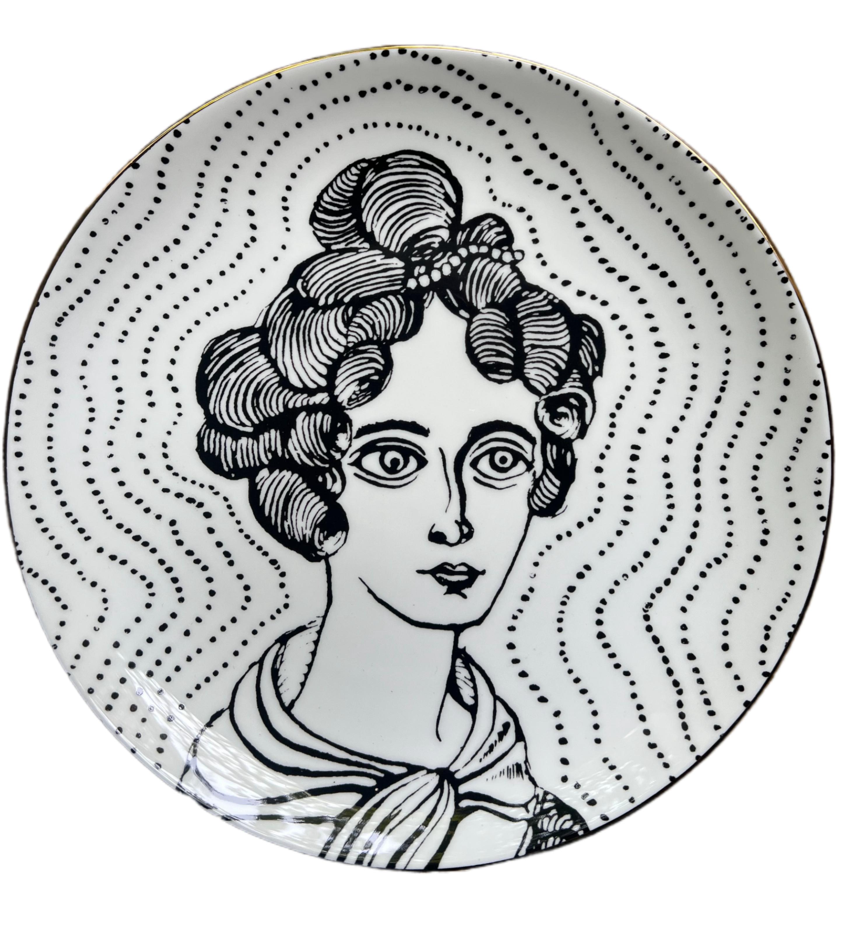 bone china with lustre rim
21 cm diameter
Grayson Perry hallmark on the back.

These decorative plates are inspired by the artwork The Great Beauty, 2024. The original piece is a cabinet heavily decorated with ceramic female portraiture, created in