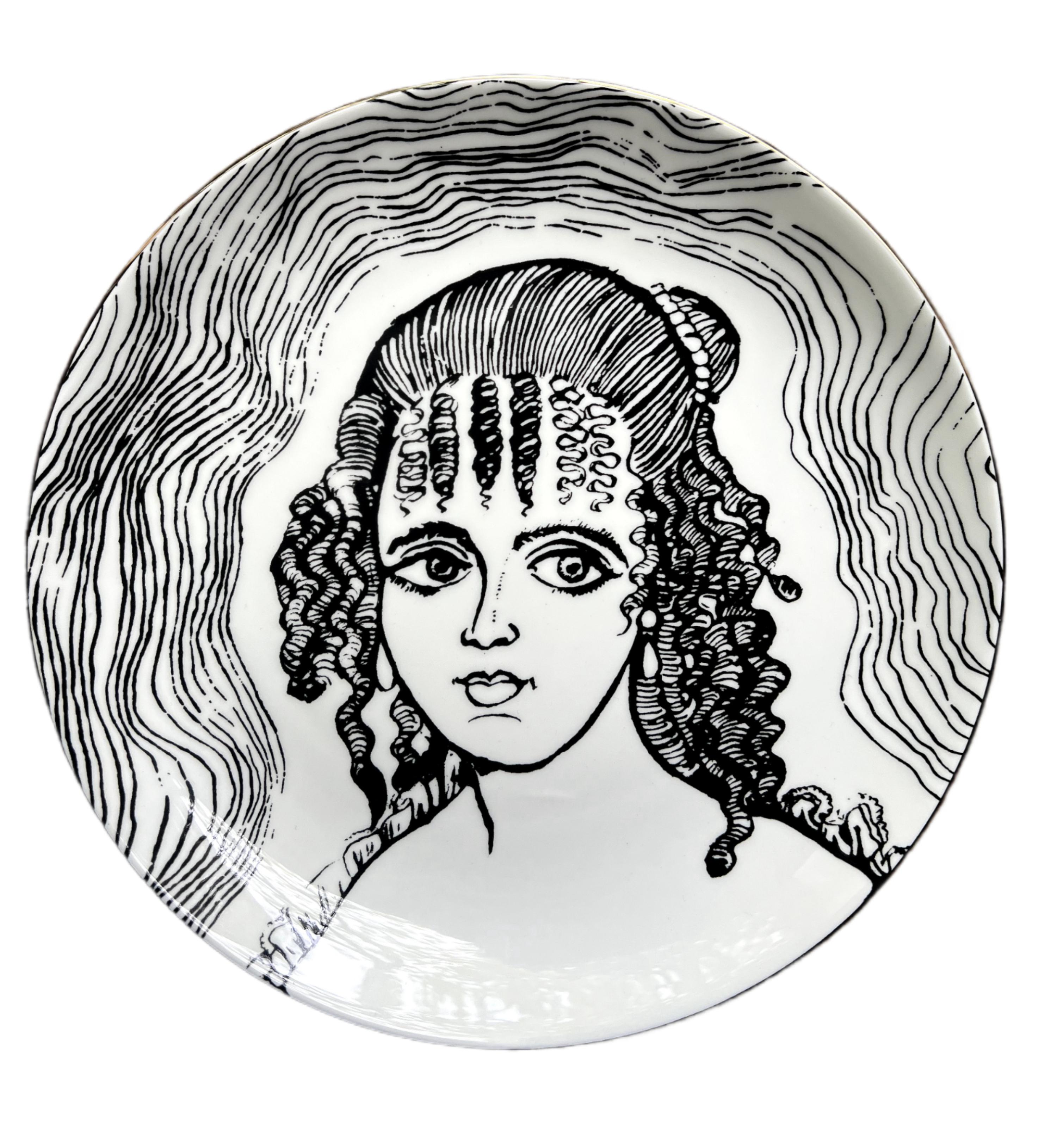 bone china with lustre rim
21 cm diameter
Grayson Perry hallmark on the back.

These decorative plates are inspired by the artwork The Great Beauty, 2024. The original piece is a cabinet heavily decorated with ceramic female portraiture, created in