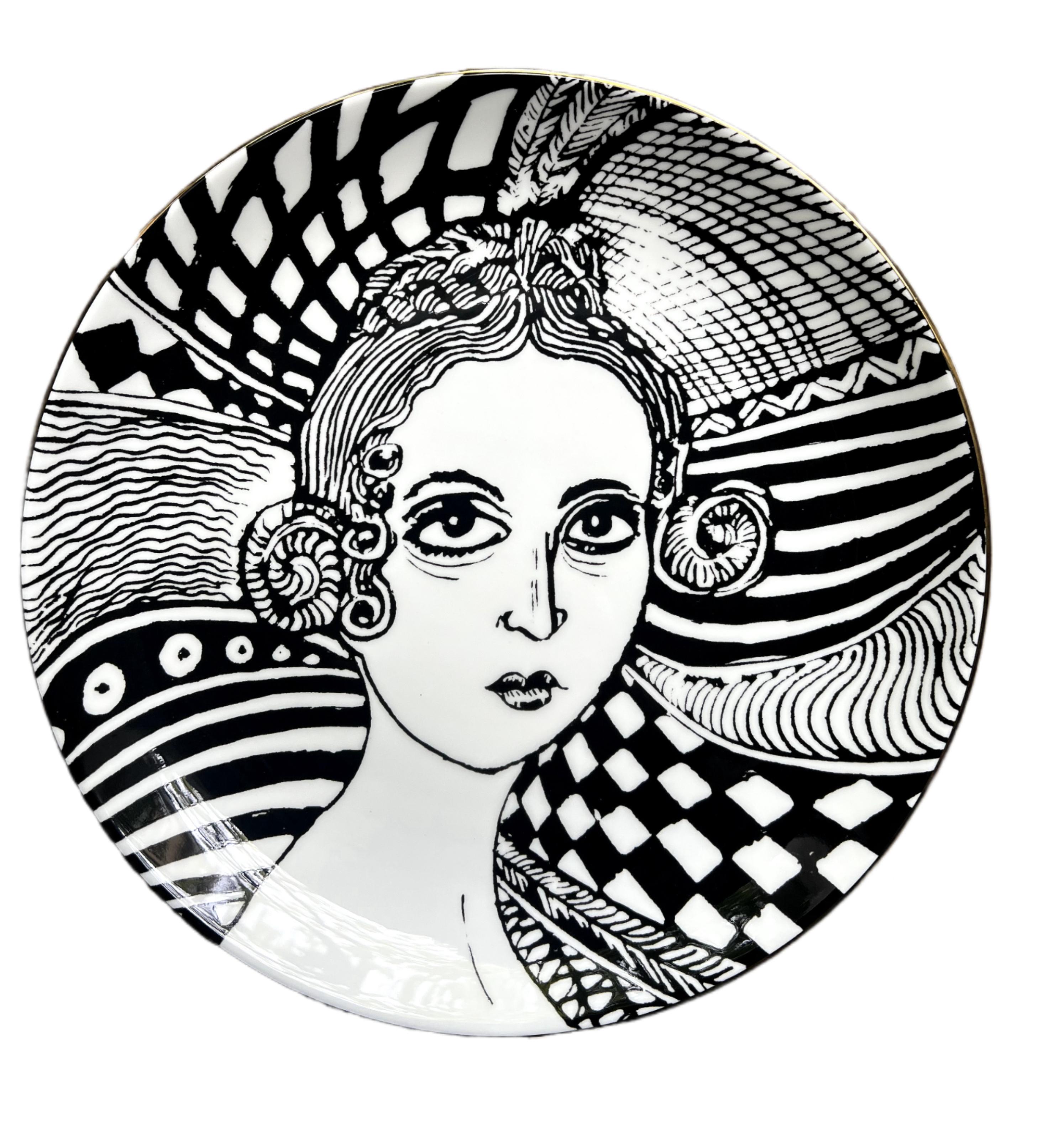bone china with lustre rim
21 cm diameter
Grayson Perry hallmark on the back.

These decorative plates are inspired by the artwork The Great Beauty, 2024. The original piece is a cabinet heavily decorated with ceramic female portraiture, created in