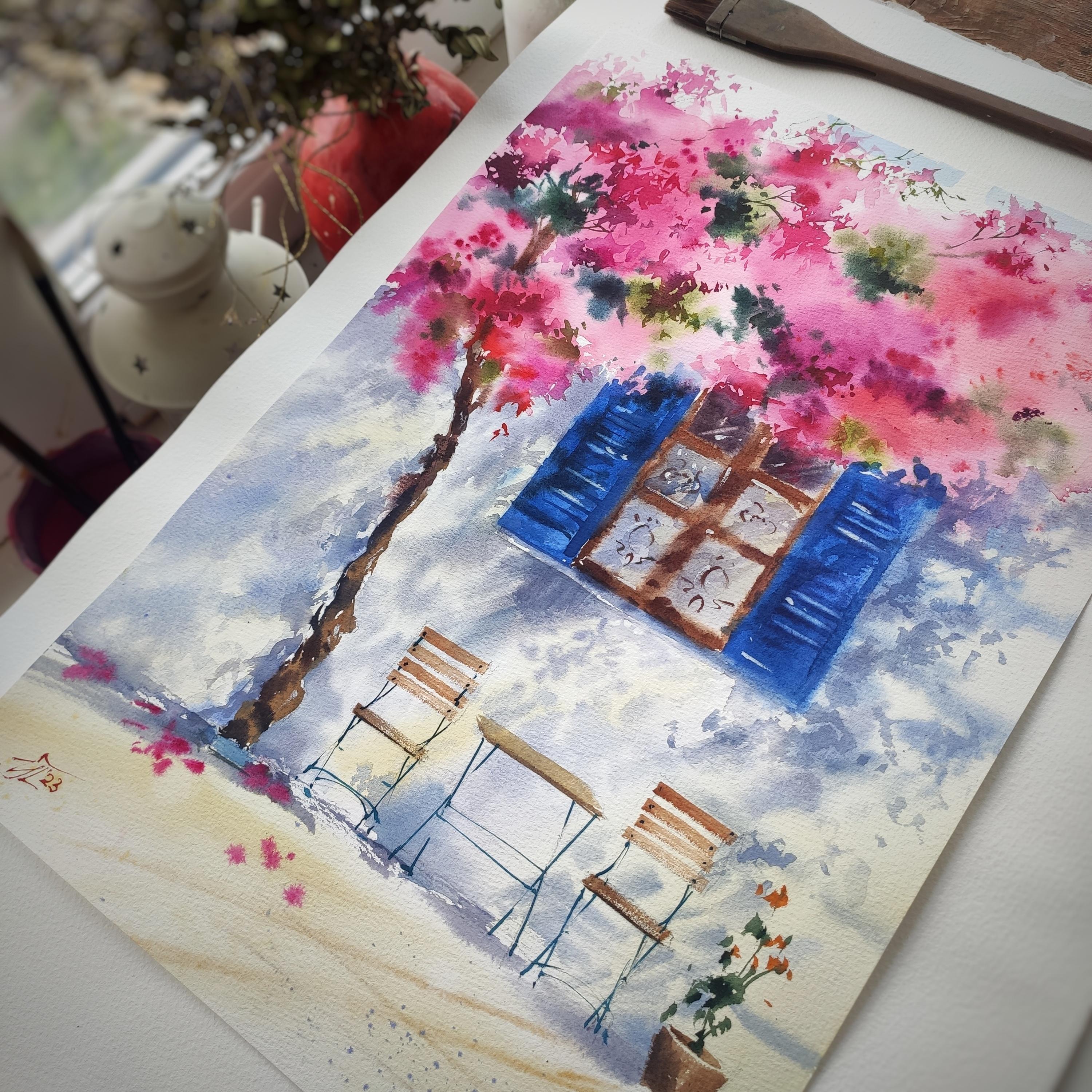 A watercolor painting with a warm southern motif, based on impressions from a trip to Crete. Bright southern flowers, authentic architecture and a relaxing atmosphere - the watercolor painting is filled with a sunny summer mood. Such a summer