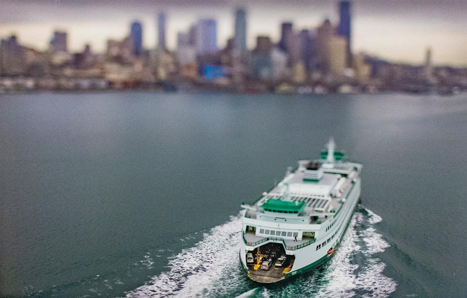 Keith Loutit  Color Photograph - Double Bay Ferry (Tilt Shift Landscape Photograph of Ferry with City Skyline)