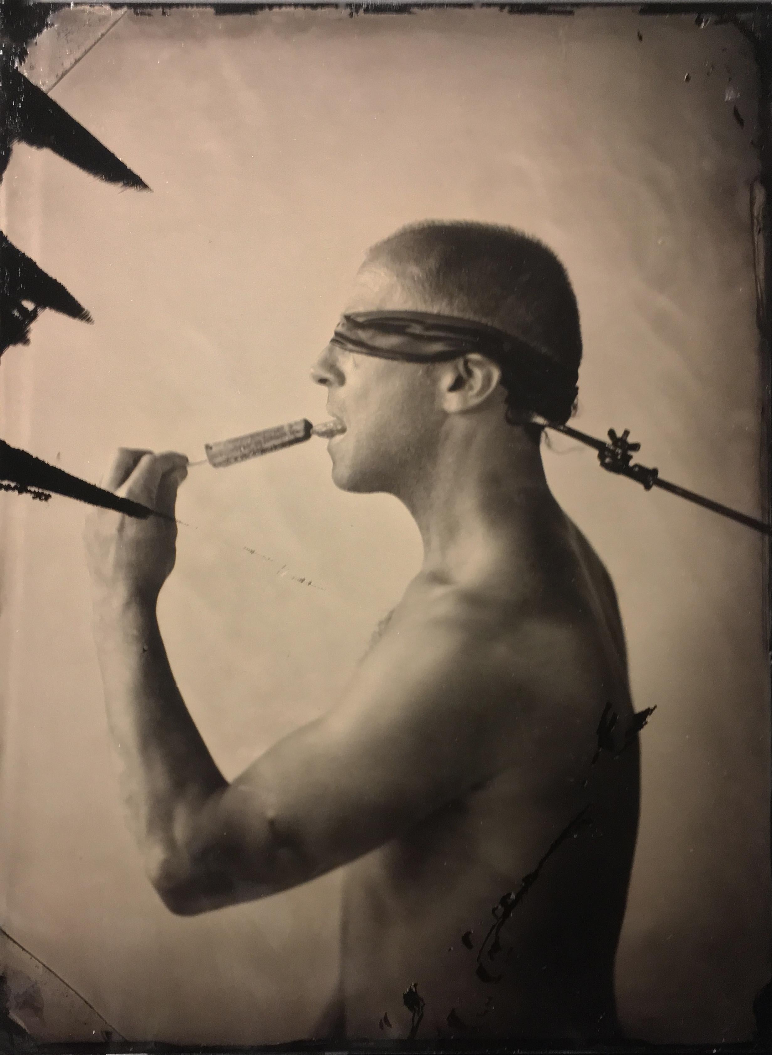 David Sokosh Figurative Photograph - Linguist (Salacious Tin Type Photo of Male Nude Licking an Ice Pop, blindfolded)