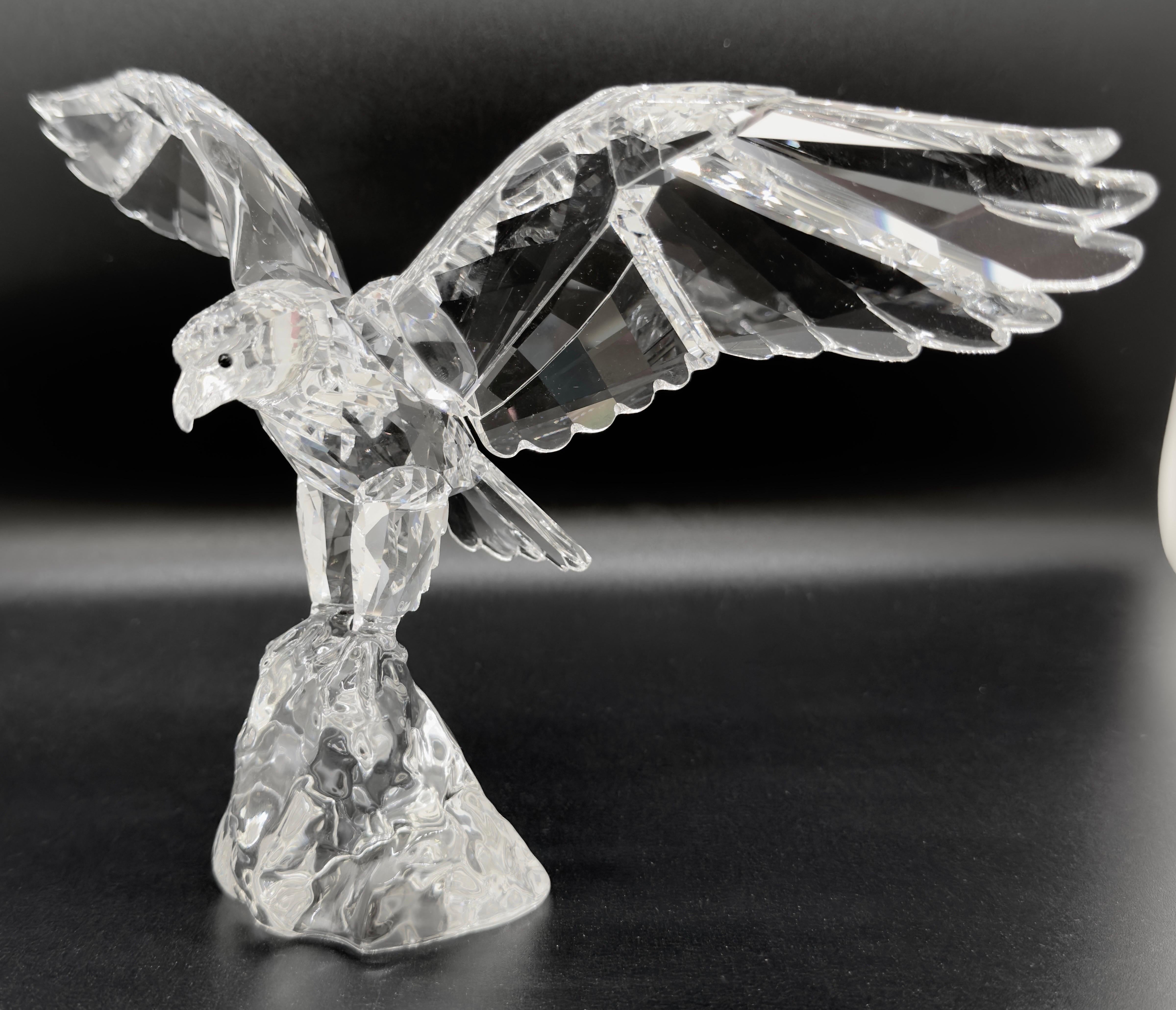 A Swarovski Eagle figurine made of high quality crystal and designed by Anton Hirzinger. Made in Australia, the figurine shows an eagle with its wings outspread and poised to take flight.  Symbol of strength and freedom, this rare Eagle sculpture is