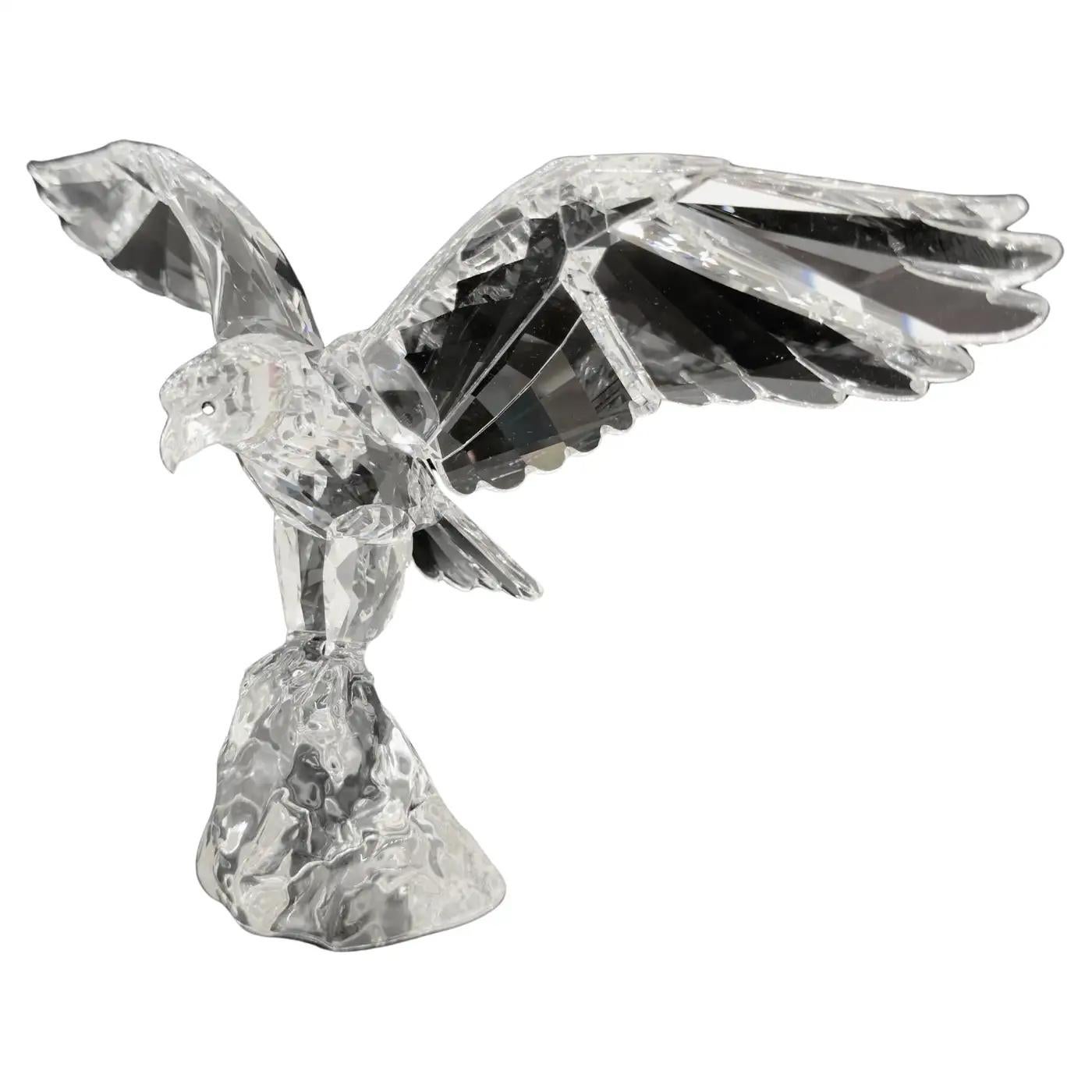 Figurine d'aigle Swarovski en cristal de haute qualité, conçue par Anton Hirzinger. Fabriquée en Australie, la figurine représente un aigle aux ailes déployées, prêt à prendre son envol.  Symbole de force et de liberté, cette rare sculpture d'aigle