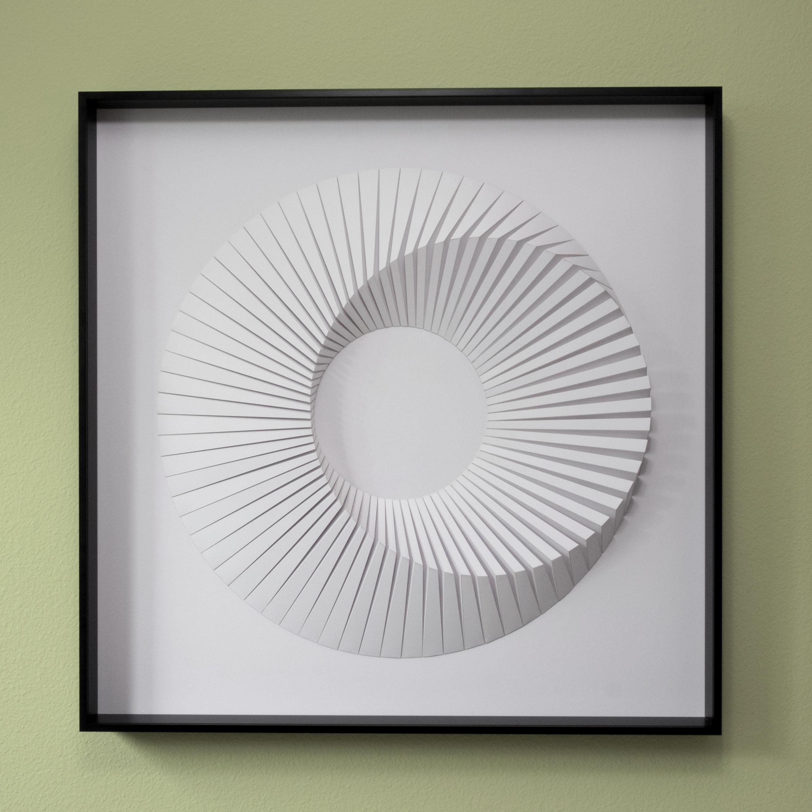 This beautiful geometric abstract wall sculpture is made out of white laser cut paper that was hand folded by Yossi Ben Abu and mound on cardboard.
