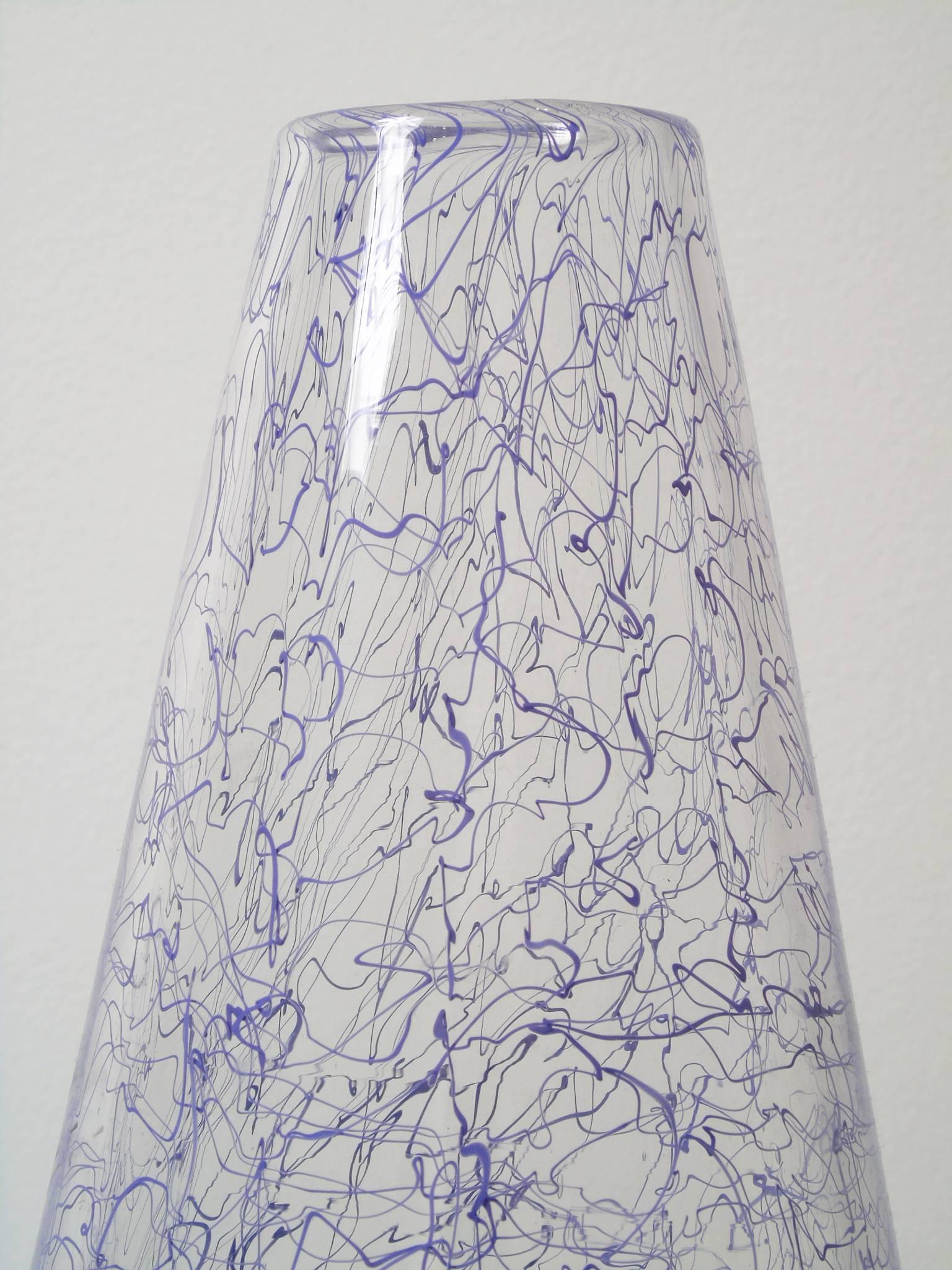 Purple #3 from Angus Powers' Squiggle Series is a blow glass vessel with kinetically generated lines throughout. The lavender colored squiggles are incorporated in clear glass. The piece is signed and dated 2018 on the bottom. 

Angus Powers teaches
