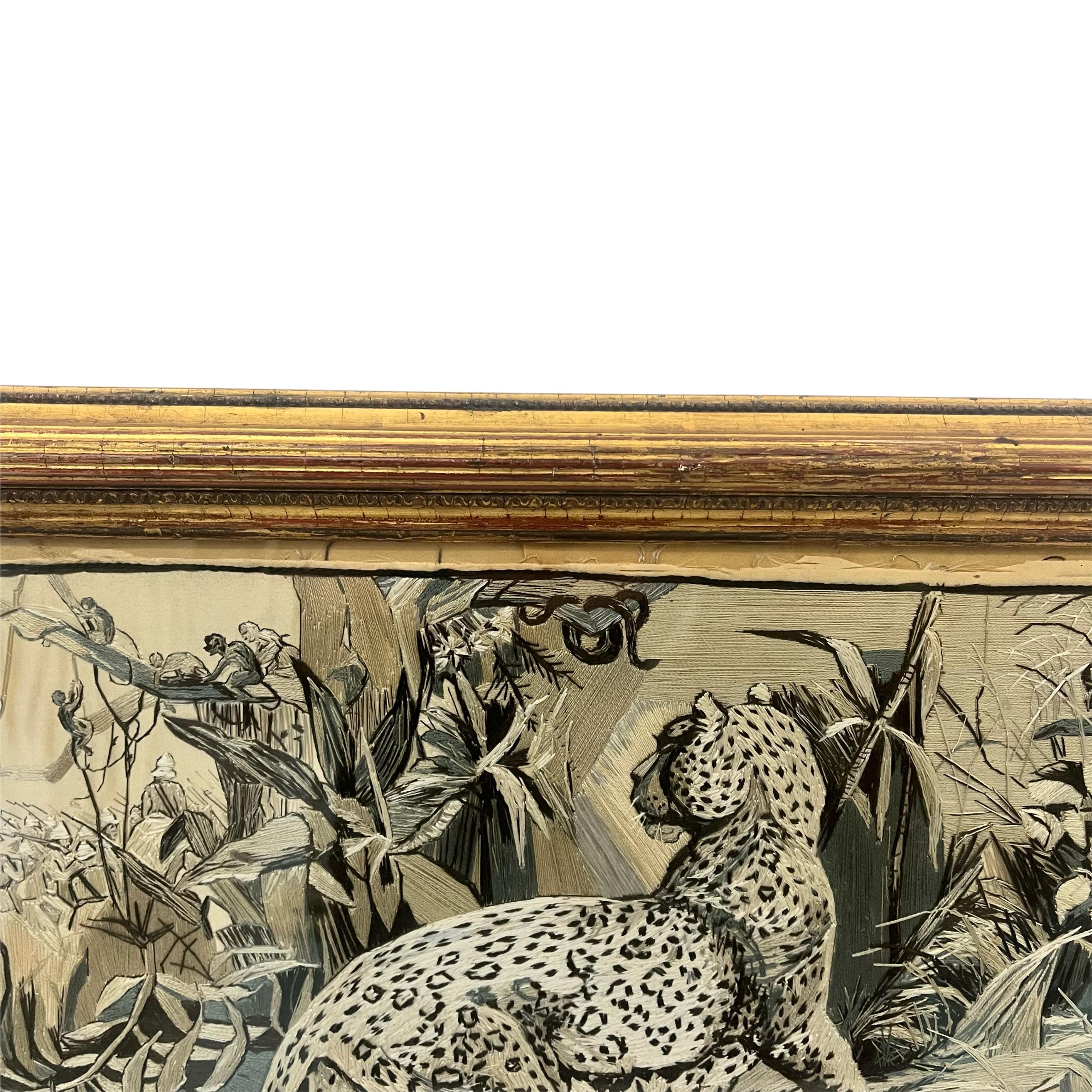 Under glass, depicting two Leopards looking to the background, where a group of soldiers are congregated, monkey's and snakes take refuge in the trees above. Below, the phrase 'In The Enemy's Country' is embroidered. 

In a period moulded gilt wood
