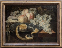 Still life of lemon upon a pewter dish, oysters, grapes, and 3 peaches. 