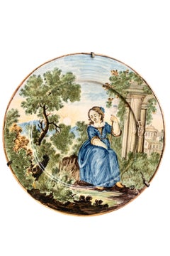 Maiolica Plate by Castelli. Young woman with spindle with classical ruins.