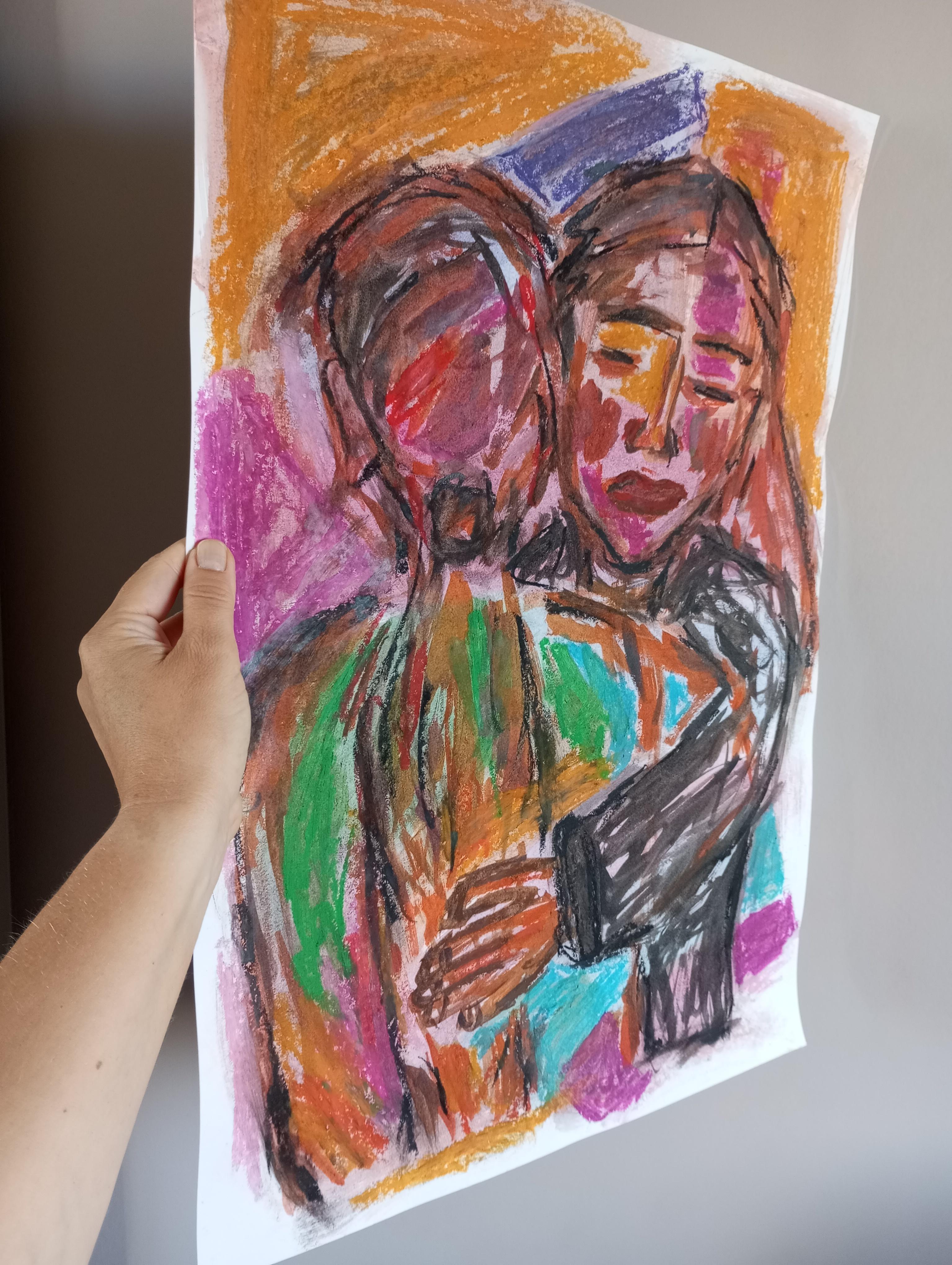 Two women hugging each other painting on paper 