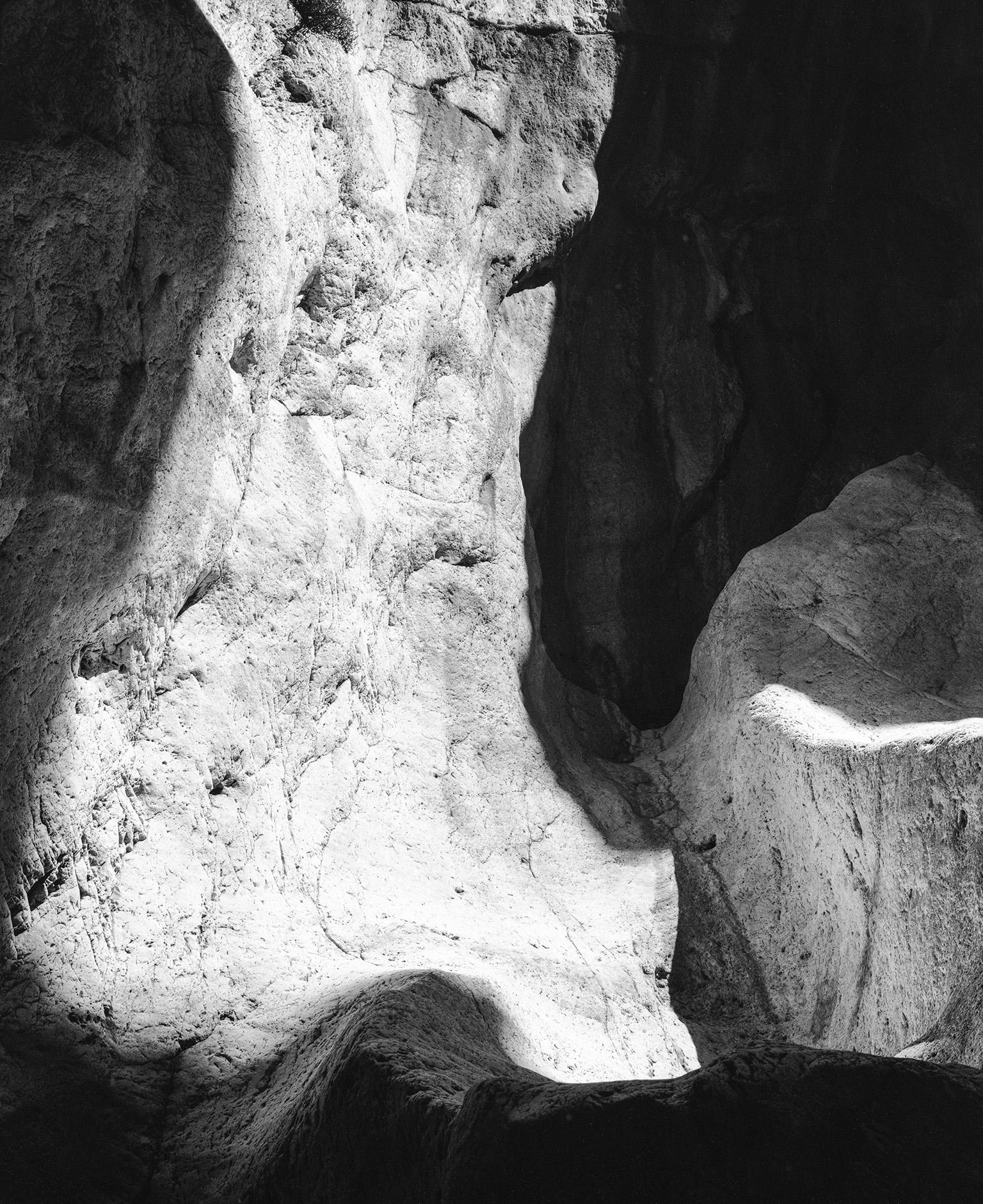 John Stathatos Landscape Photograph - Earth VI - Black and White Photograph, Cave, Rocks, Natural Landscape, Light