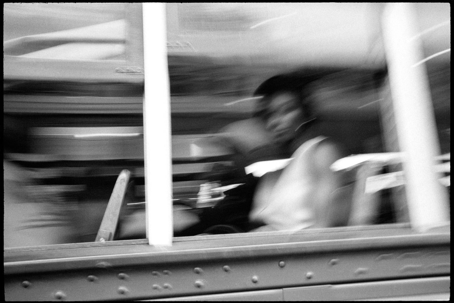 This is a 39.5 x 59 inches archival giclée black and white print on archival exhibition paper. It shows a woman looking straight into the camera from the window of one of the New Orleans historic street cars.  It is part of a limited edition of 6
