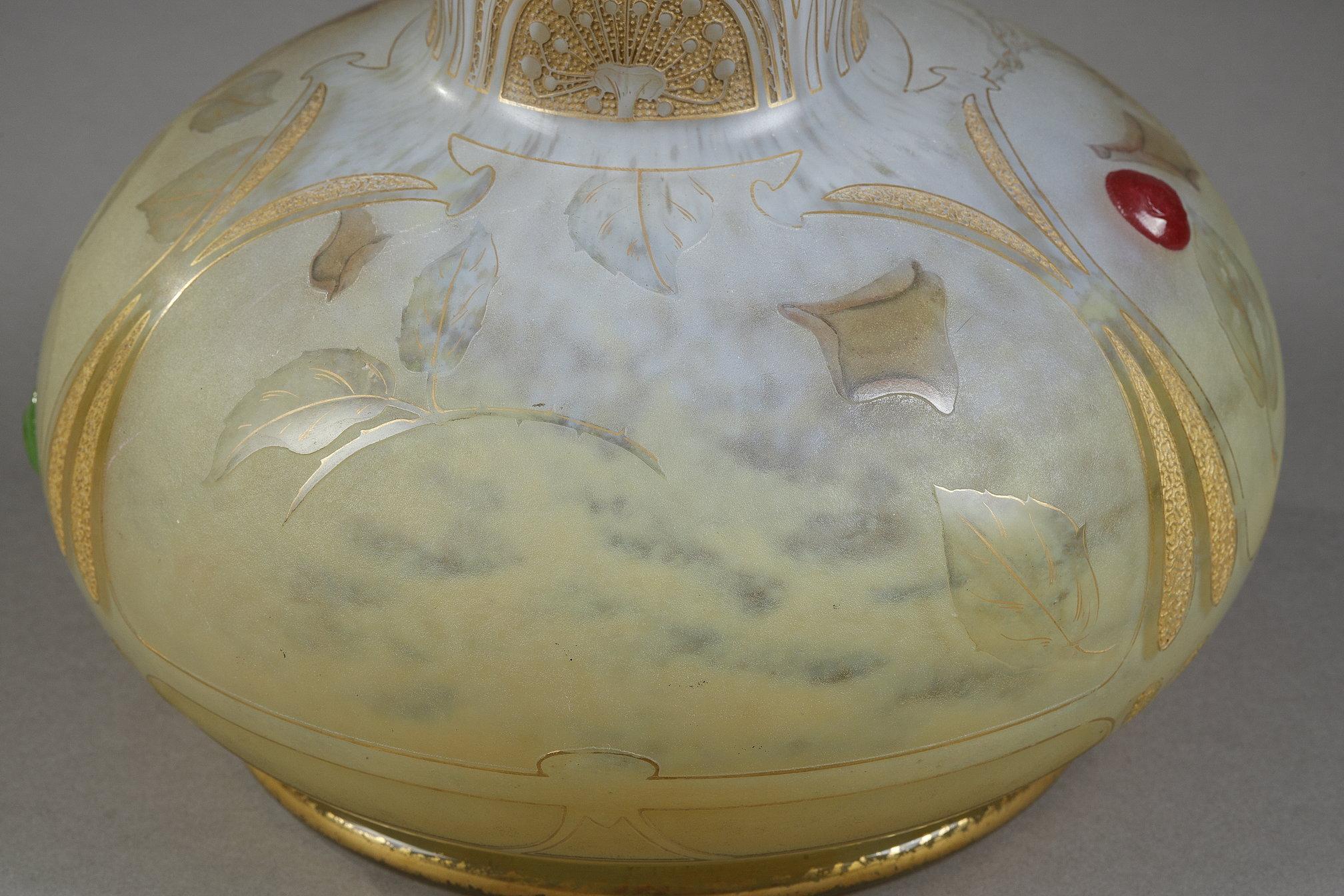 A tall bud vase with a butterfly
by DAUM

Beautiful tall long-neck vase decorated with roses, a butterfly and cabochons
blown-molded glass
with an acid-etched decor
decor painted with enamel
with gold highlights
with applied colored glass