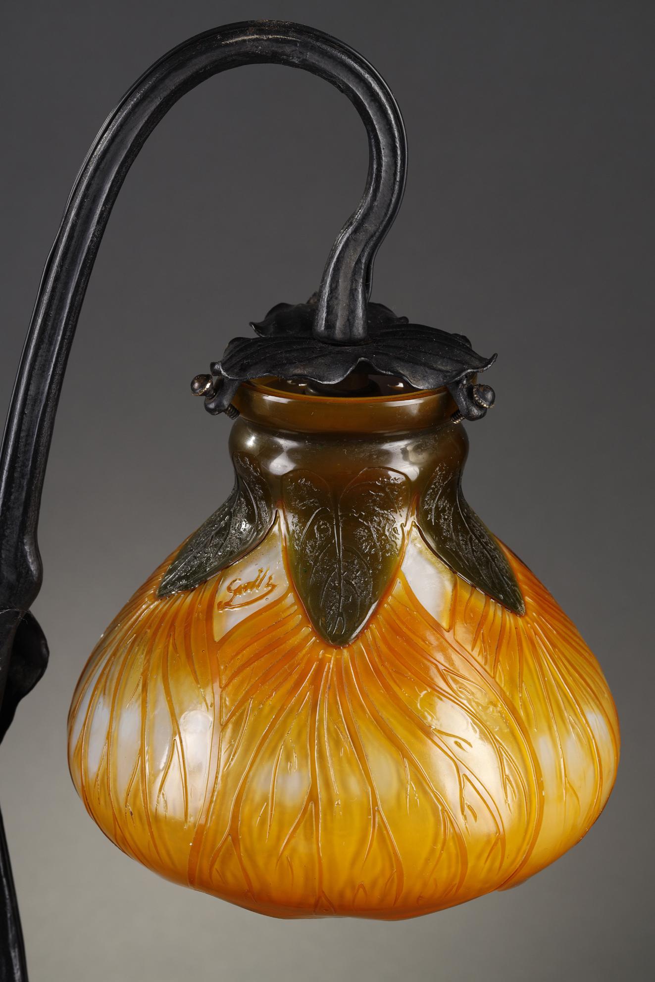 Rare lamp with velvetleaf flowers
by Emile GALLE (1846-1904)

Mounted with a foliate ornated blackened wrought iron base.
Bulb covers in green and yellow-orange multilayer glass on a white background, 
decorated with ribbed and acid-etched