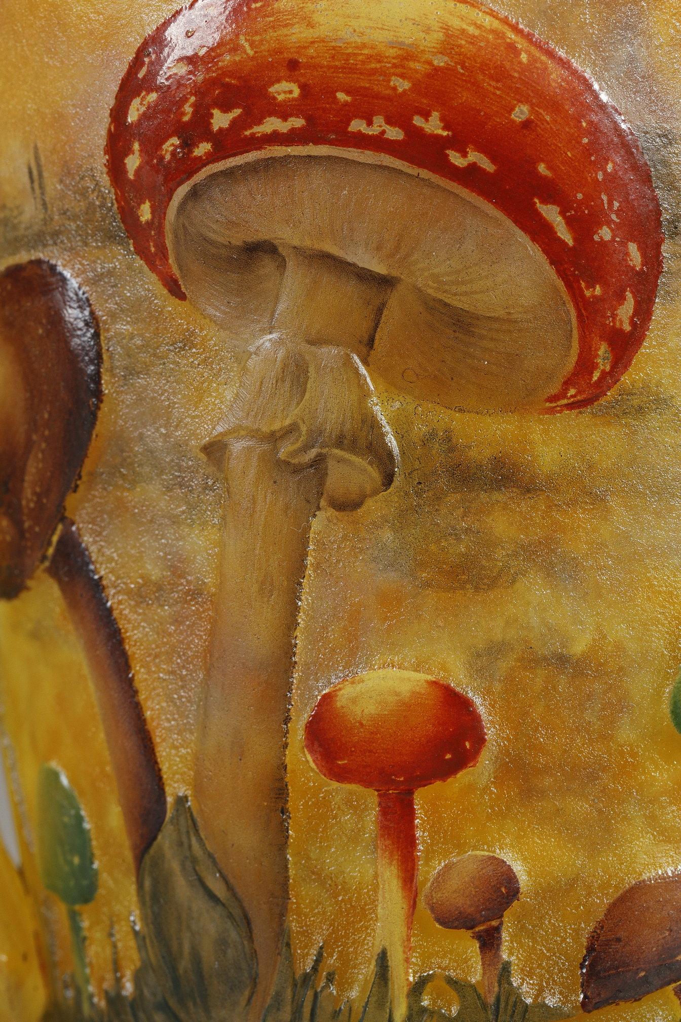 Vase with Mushrooms
by DAUM
 
A rare blow-molded vase, 
with decoration of mushrooms,
entirely released with the acid and painted with enamels.
Flanked by two hot-applied handles.

Signed underneath 