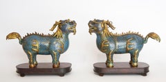 Pair of Qilin in cloisonné resting on wooden bases