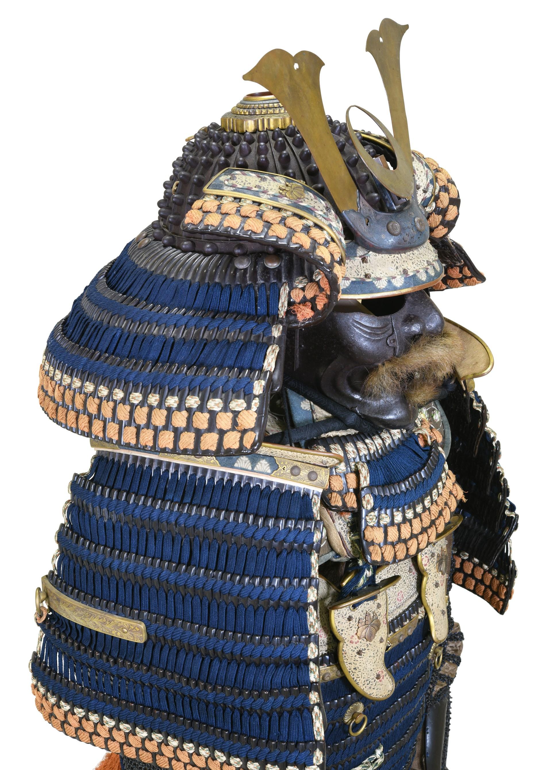 The samurai armor described is an exquisite example Japanese craftsmanship from the Edo period featuring a 24-plate hoshi bachi kabuto (“star bowl,”alluding to the protruding rivets) of rounded form, with elaborate gilt and copper hachimanza