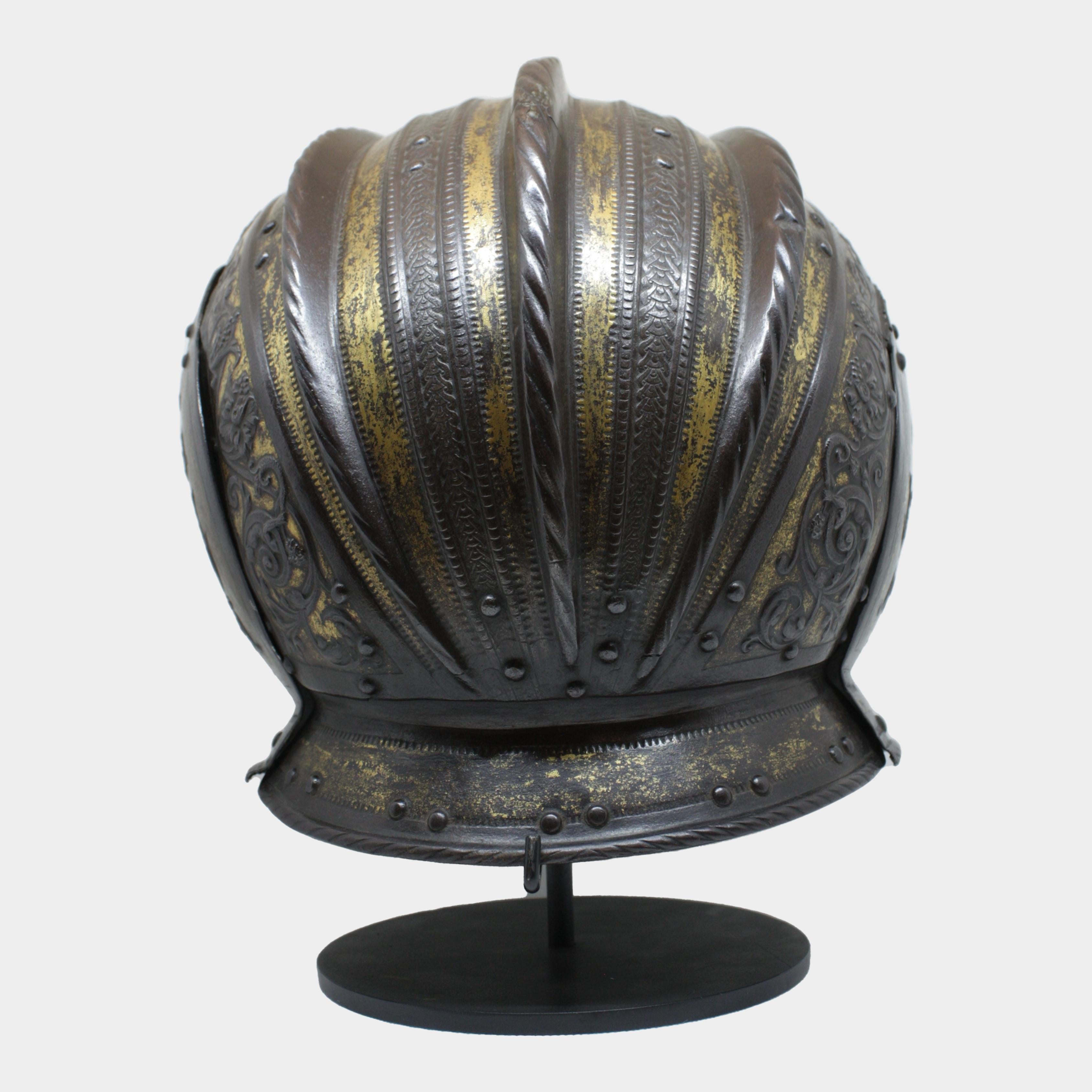 This 17th-century parade helmet, made in Milan, is an outstanding example of Lombard weapons art of the period. Its iron frame is embellished with embossing and chiseling techniques, which lend depth and fine detail to the decorations. Embossing