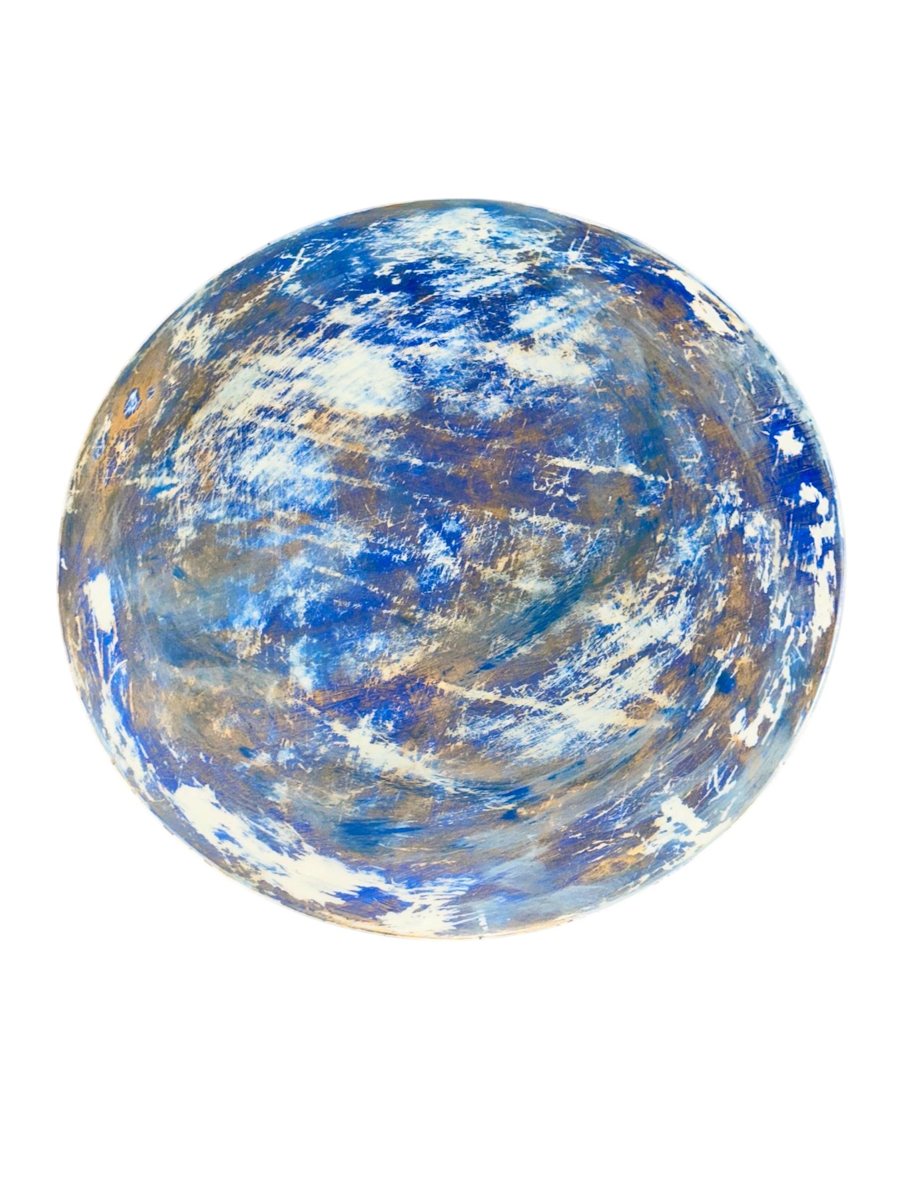  Elevate your modern living room with this stunning abstract blue hand-painted side table, expertly crafted by multidisciplinary artist Mahesh Sharma. Featuring vibrant blues, textured artistry, and a one-of-a-kind resin finish, this 46 cm diameter
