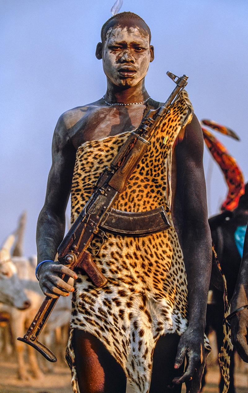 Carol Beckwith and Angela Fisher Color Photograph - Dinka Warrior with Leopard Skin and Kalashnikov Rifle, South Sudan