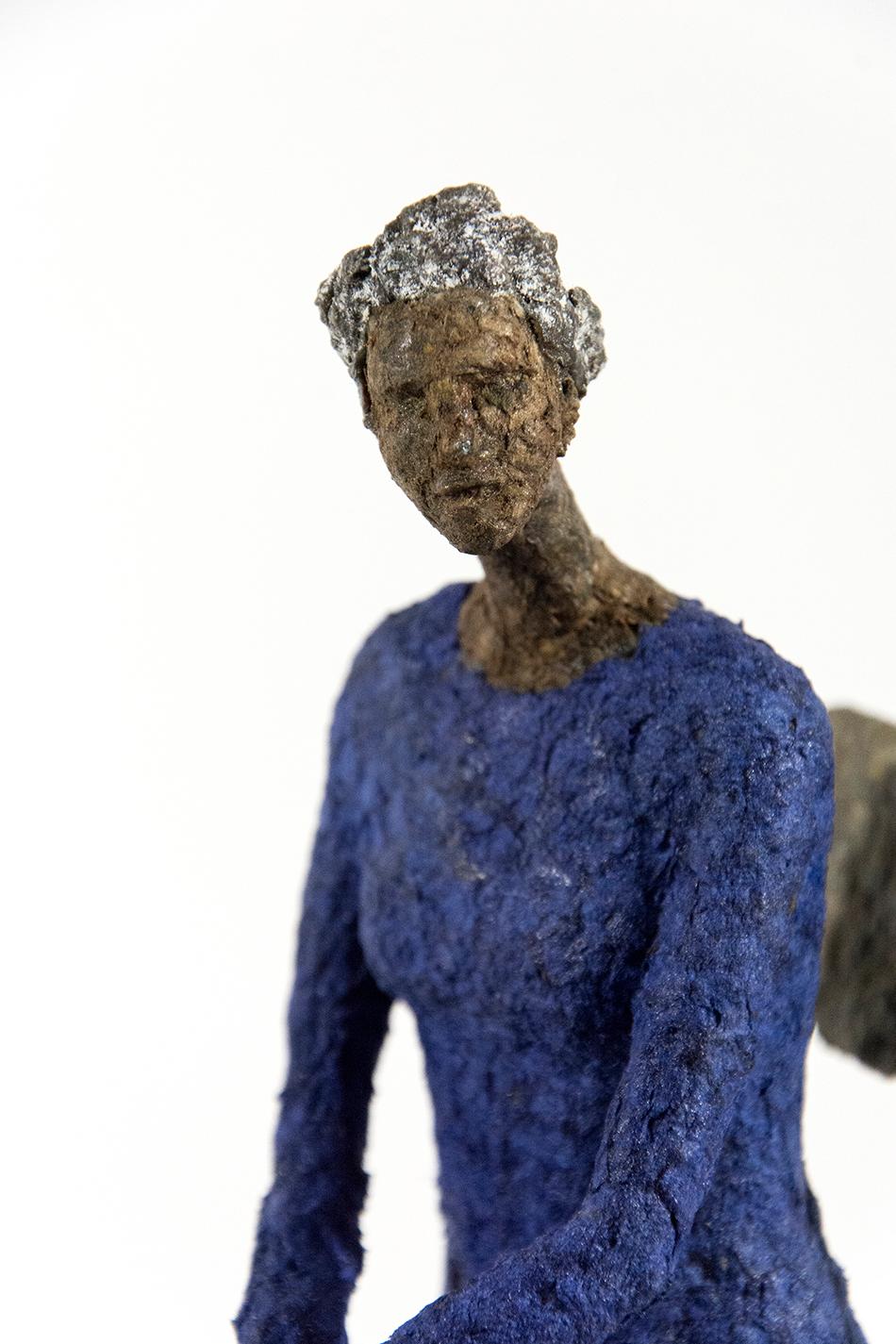 A pair of seated figures in yellow and blue wait quietly in this contemplative paper mache artwork by Paul Duval. The elongated shapes of the women and chairs are reminiscent of the expressive forms used by modernist Alberto Giacometti.

Paul Duval