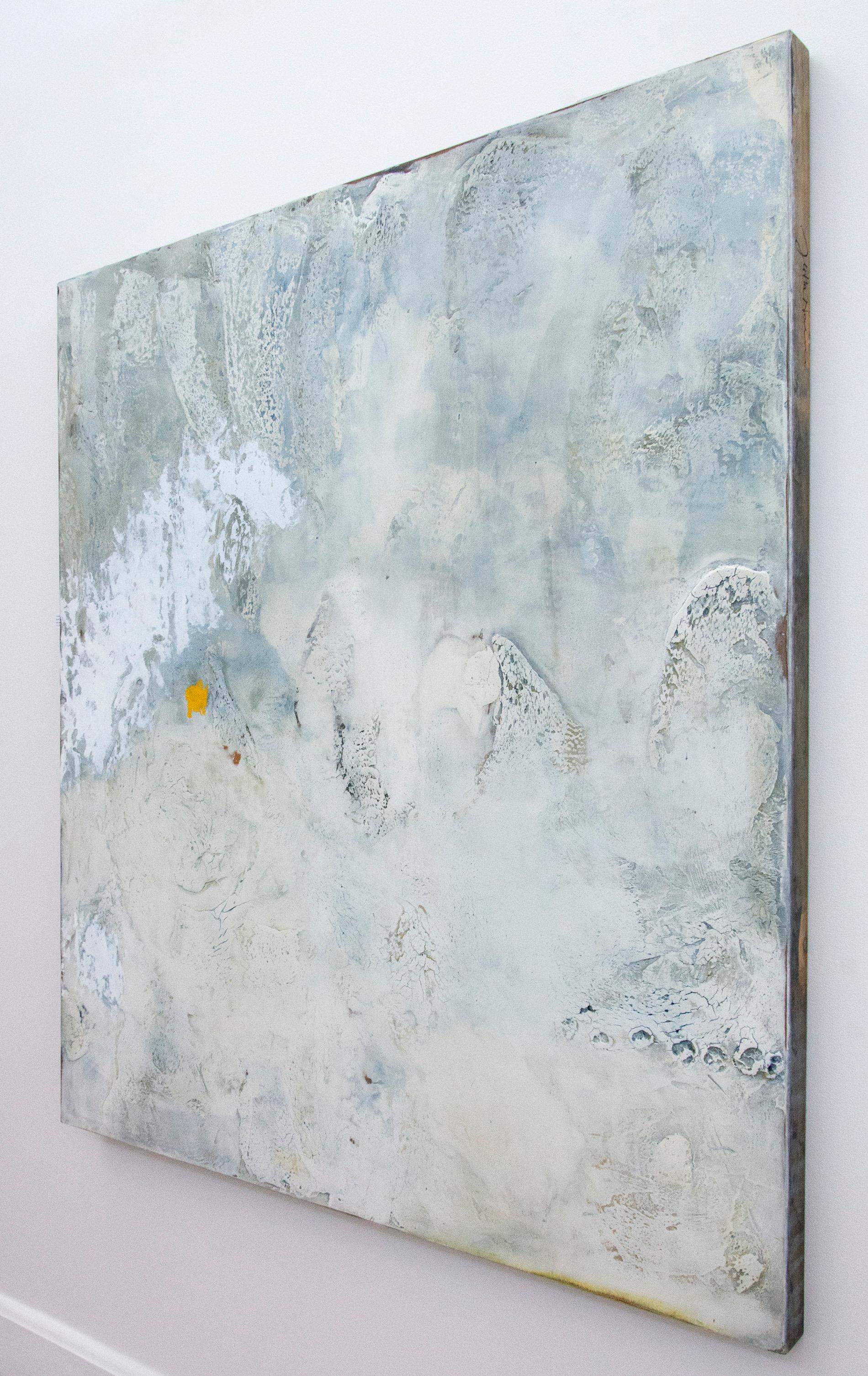 Washes of dove grey and light blue swirl across the tactile surface of this atmospheric plaster and pigment painting by Jutta Naim. Marks pulled by hand through the plaster, thick and deliberately cracking dynamically in areas, create a lively and