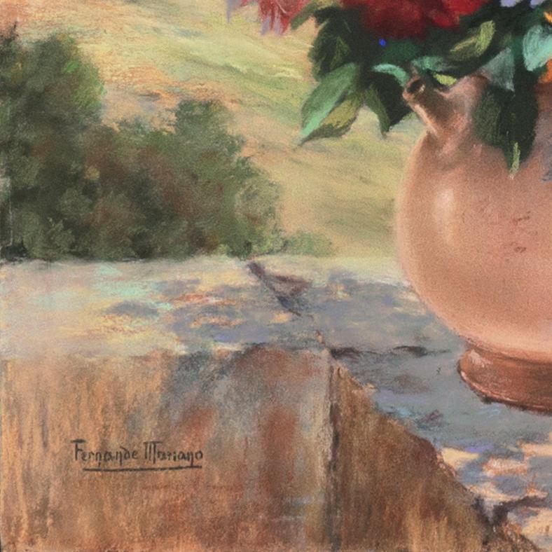 A bright and breezy still-life showing a variety of spring flowers informally arranged in a pink ceramic vase set on a stone ledge with a panoramic view beyond towards the ocean and distant hills. Signed lower left, 'Fernande Mariano' (20th century)