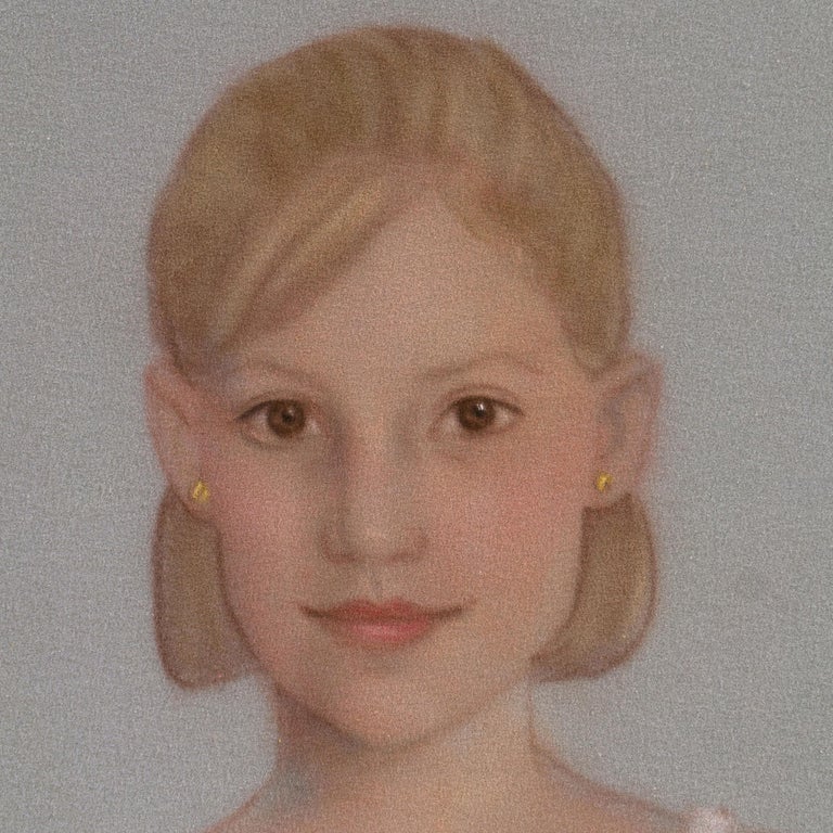 A late twentieth-century American school portrait of a girl posed against a light slate background and gazing back at the viewer.  

Displayed in a cream mat.
Matted dimensions: 14.5''H x 13''W x .13''D