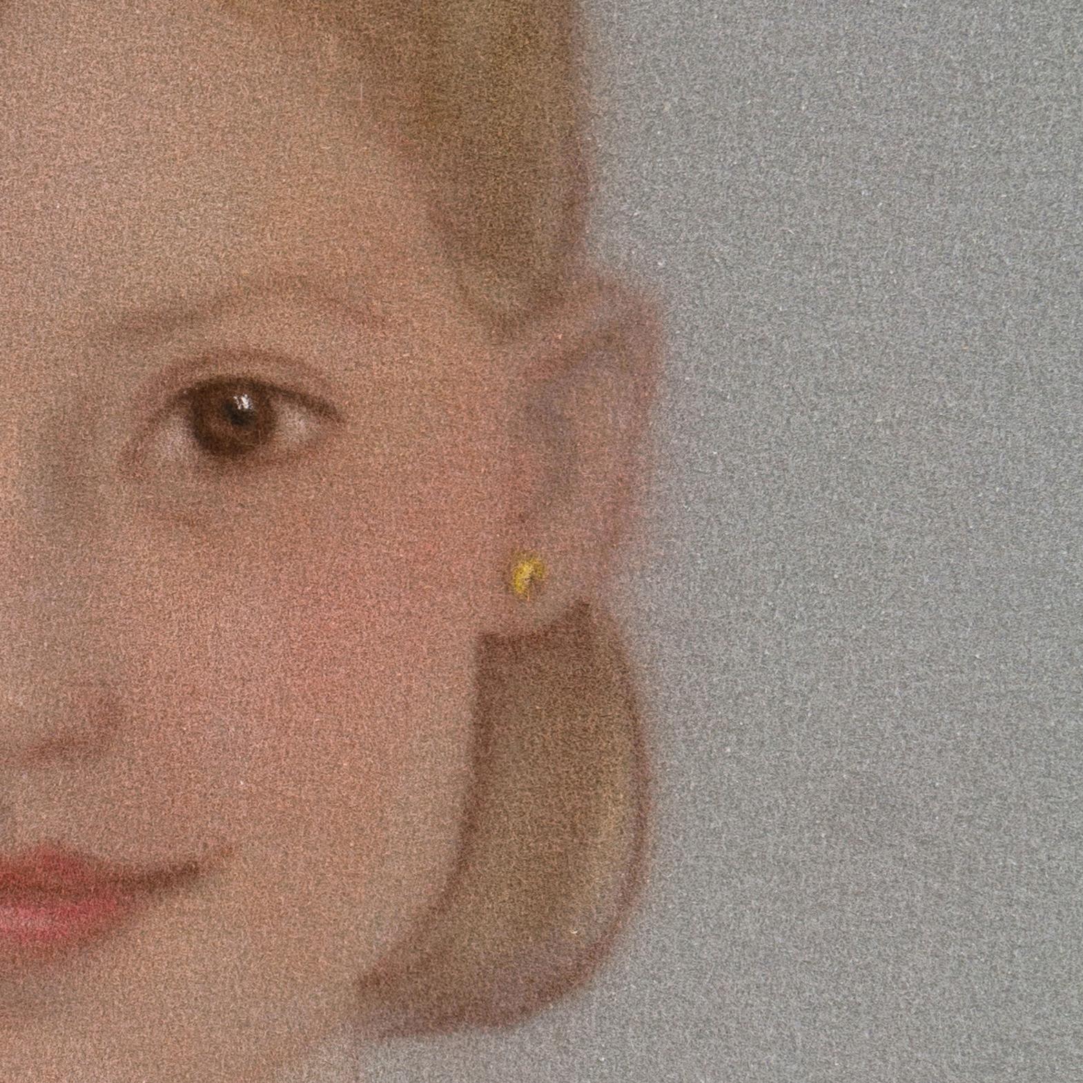 A late twentieth-century American school portrait of a girl posed against a light slate background and gazing back at the viewer.  

Displayed in a cream mat.
Matted dimensions: 14.5''H x 13''W x .13''D