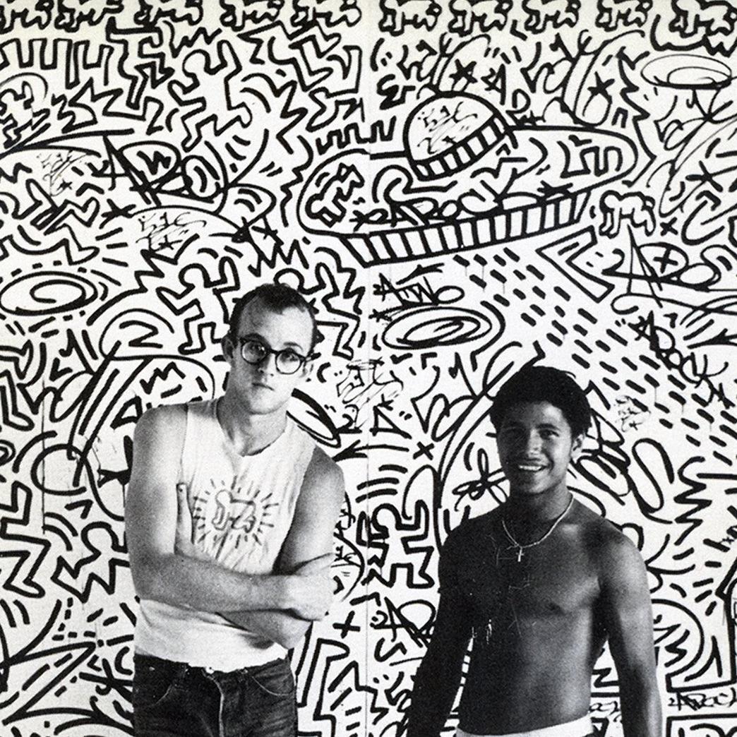 Keith Haring with LA2, Tony Shafrazi Gallery 1982:
Rare original 1982 announcement card for an early exhibition of Keith Haring’s work at Tony Shafrazi Gallery, New York, October 9 – November 13, 1982.  The front of the card features a photograph of