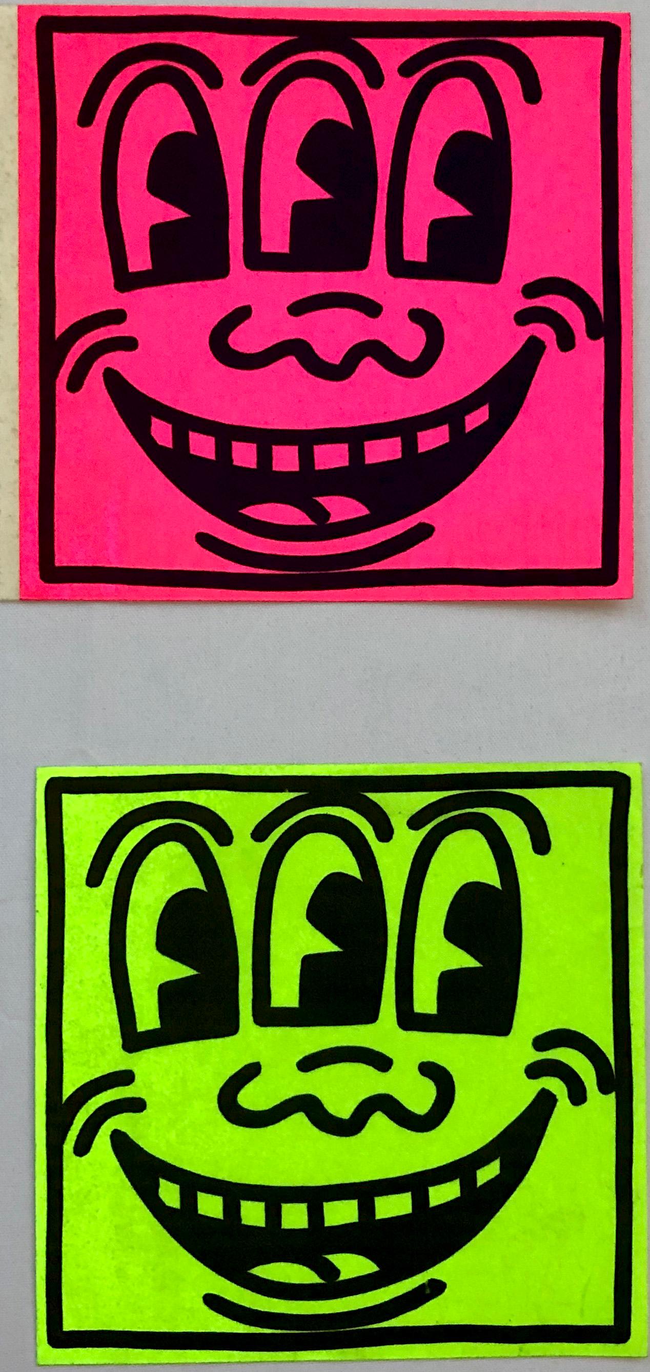 Keith Haring Three Eyed Smiling Face: Set of 3 stickers c. 1985/1986
A set of three vintage Keith Haring 1980s Pop Shop stickers c.1985/1986: Neon Pink and Neon Green Three Eyed Smiling stickers. Would look fantastic framed. 

Vintage self-adhesive