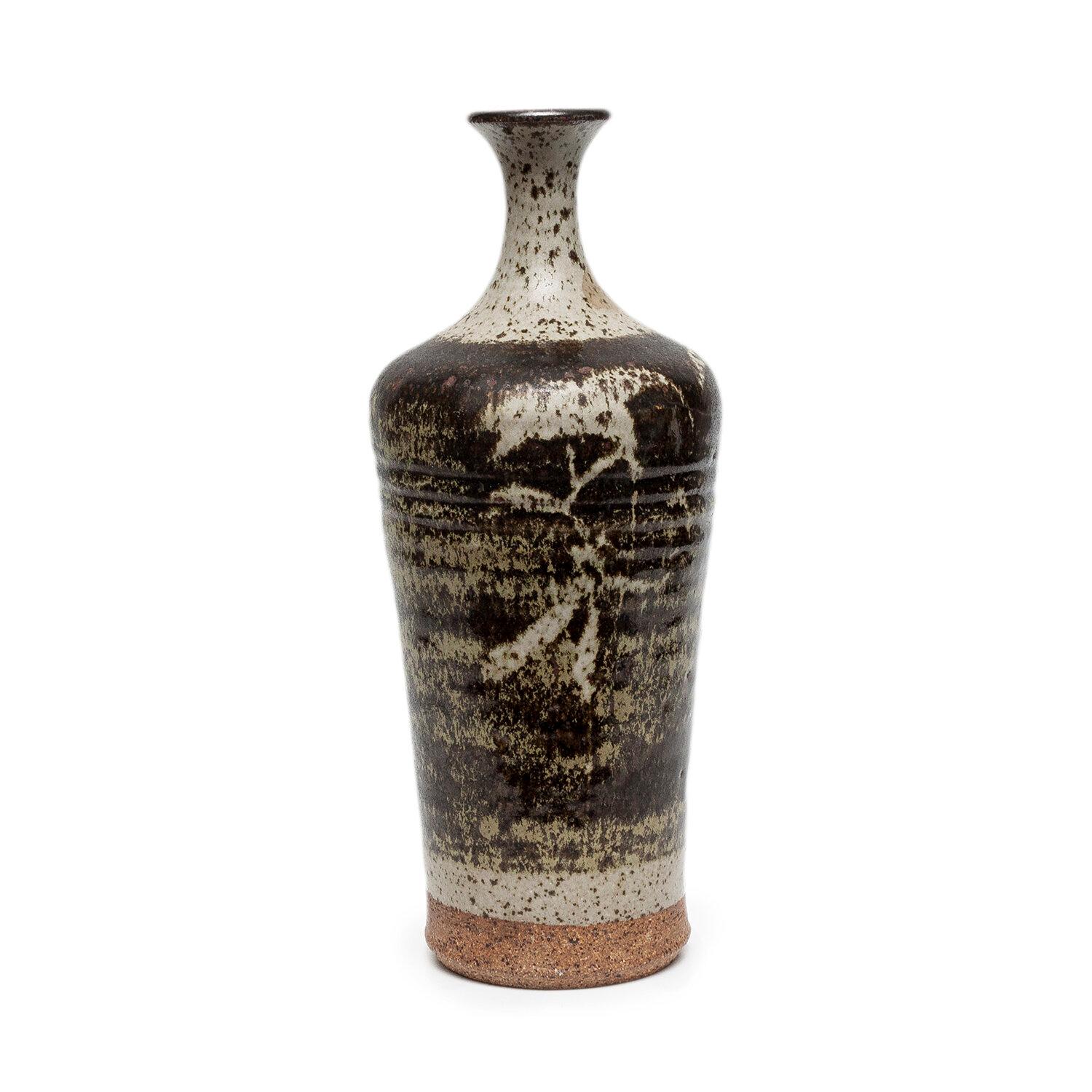 Rare bottle vase form by Peter Voulkos.  midcentury modern.
Peter Voulkos
stoneware and glaze
11.25 x 4.75 x 4.75”
circa 1960
signed “Voulkos” on base

A West Coast potter and sculptor, Peter Voulkos (1924-2002) led in the development of pottery as