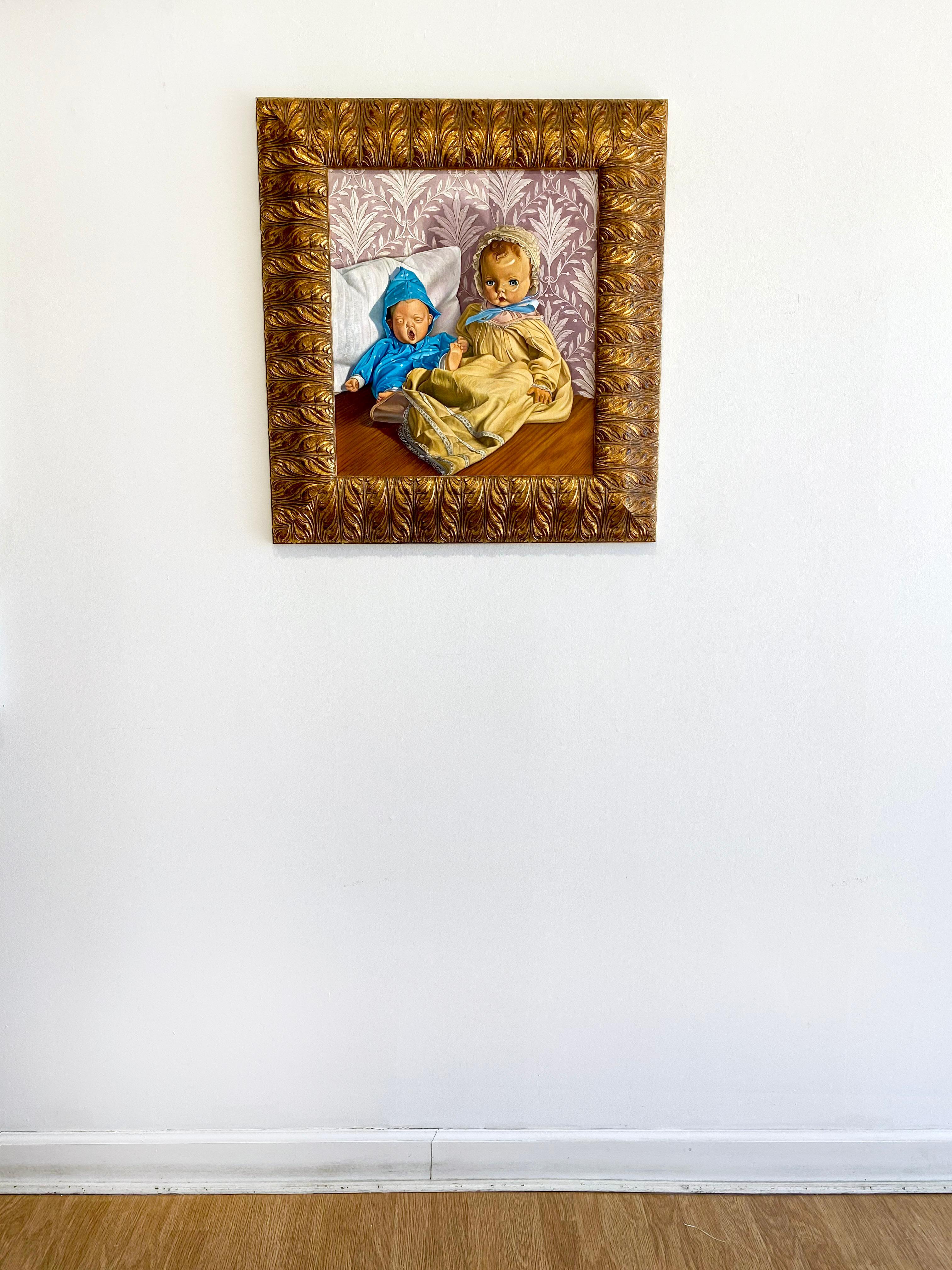 'Sid and Nancy' by American artist Thomas Hoffman, oil on linen, 20 x 18 inches. This photorealistic painting features an antique doll sitting next to a yawning baby against a backdrop of old decorative wallpaper. It is framed in an embellished