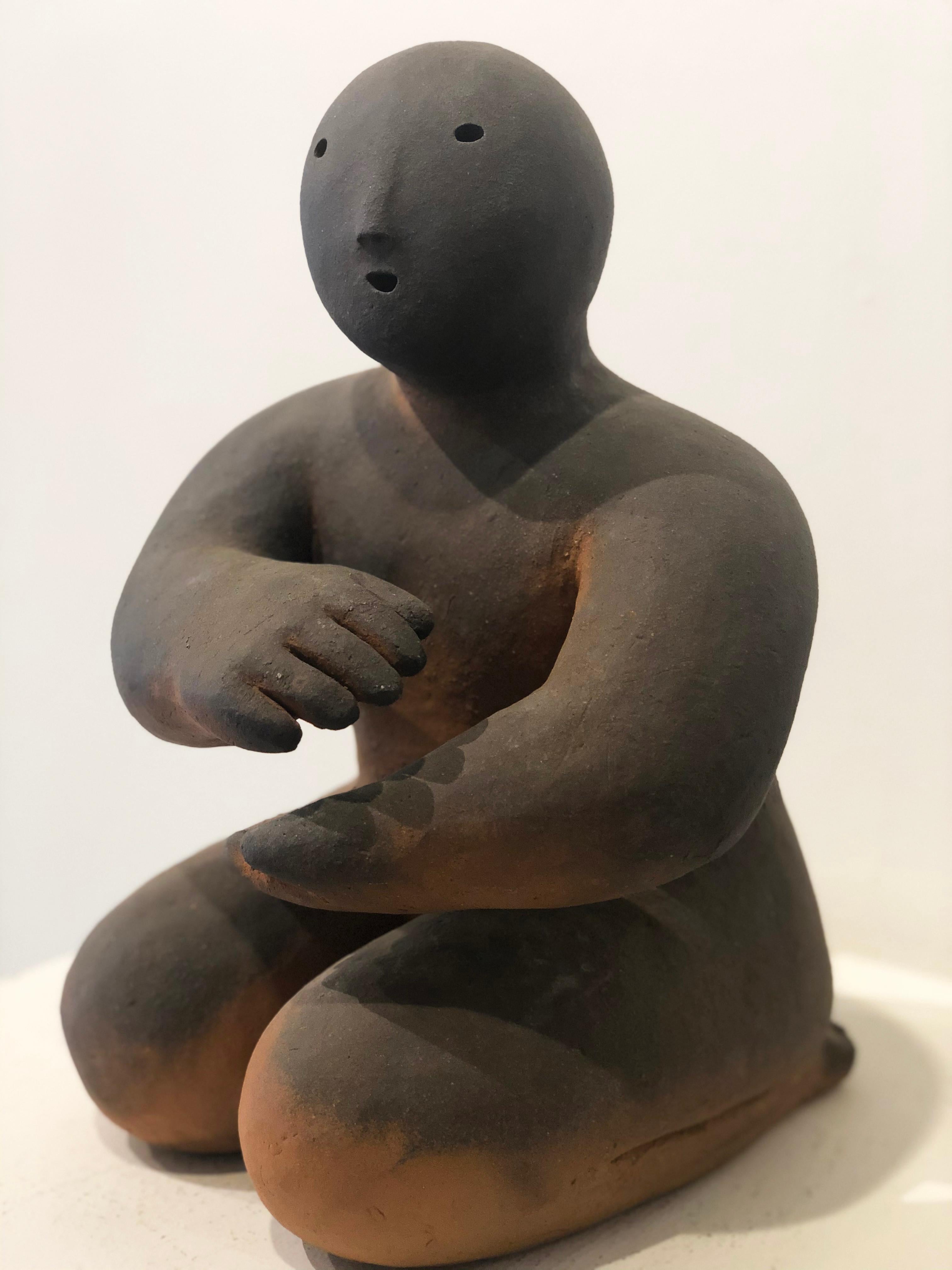 'Holding Energy' 2018 by Connecticut artist, Joy Brown. Wood fired stoneware, 14.5 x 10.5 x 10.5 in. Influenced by Japanese aesthetics and using their traditional pottery methods, Brown creates child-like, anthropomorphous figurative sculptures in