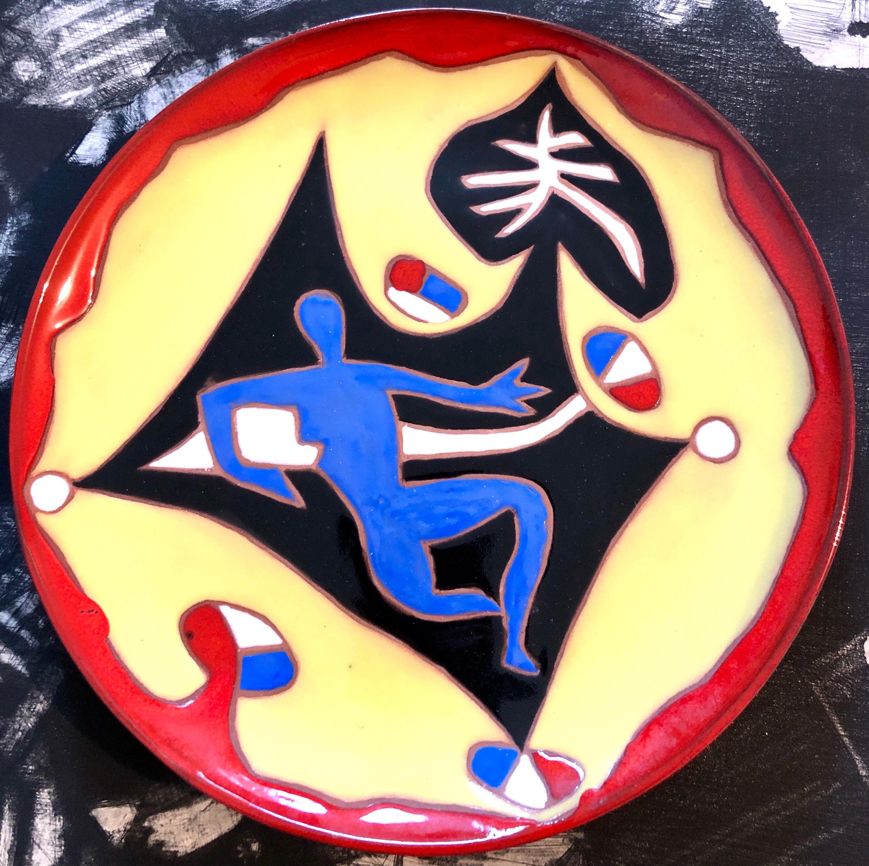 Vintage Jean Lurcat glazed fired enamel wall plaque ceramic plate limited edition hand inscribed faience Ceramique Saint Vicens charger.  It depicts a highly stylized figure in bright, vibrant colors. Beach scene with swimmer and French Flags