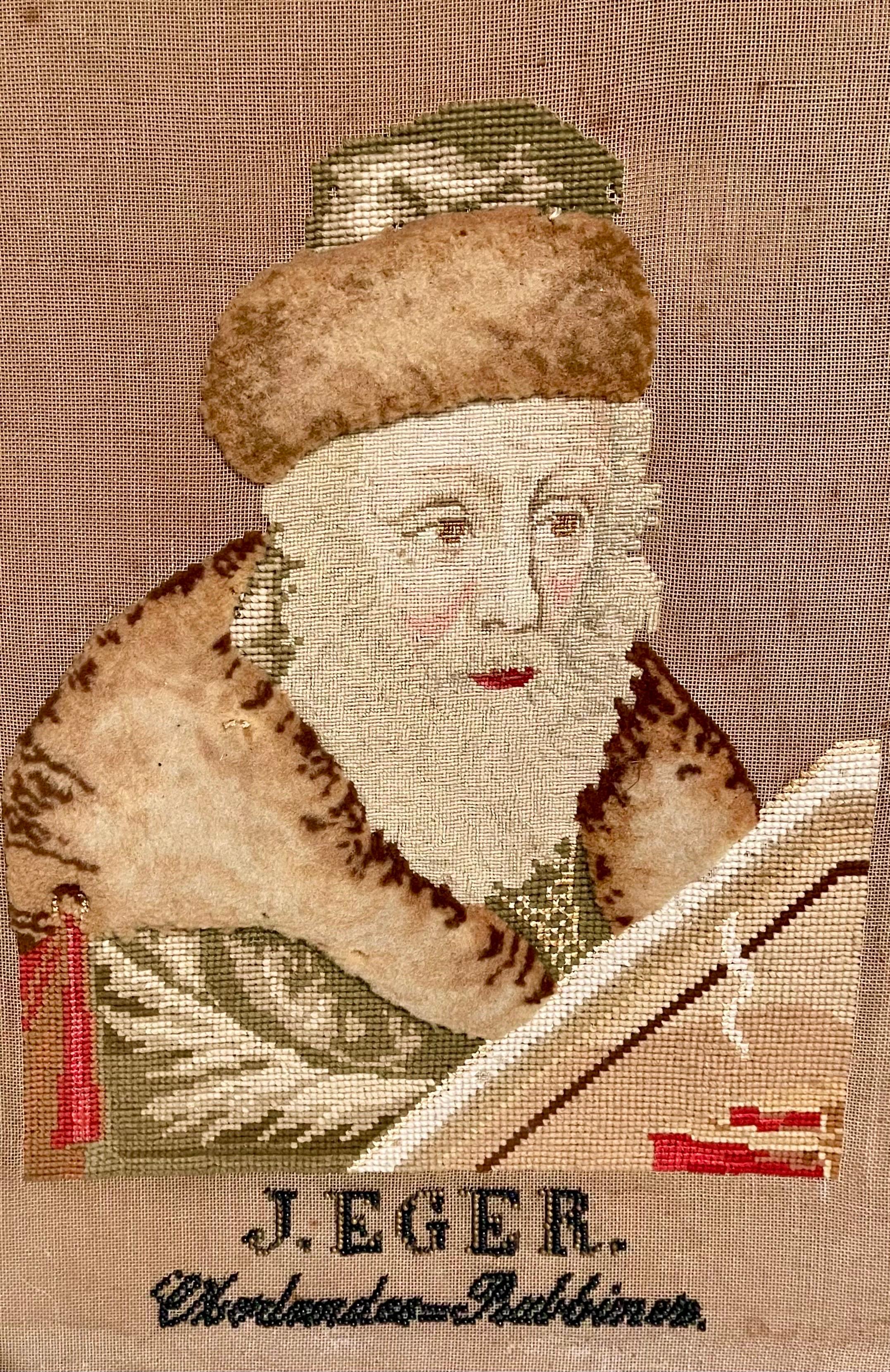 Dimensions board backing is 2 X 18.5  board opening is 16.5 X 13 inches
19th Century framed tapestry of a Rabbi, embroidered sampler, with beaded script below. (it reads J. Eger Oberlandes Rabbiner or Oberlander Rabbiner) There is some sort of