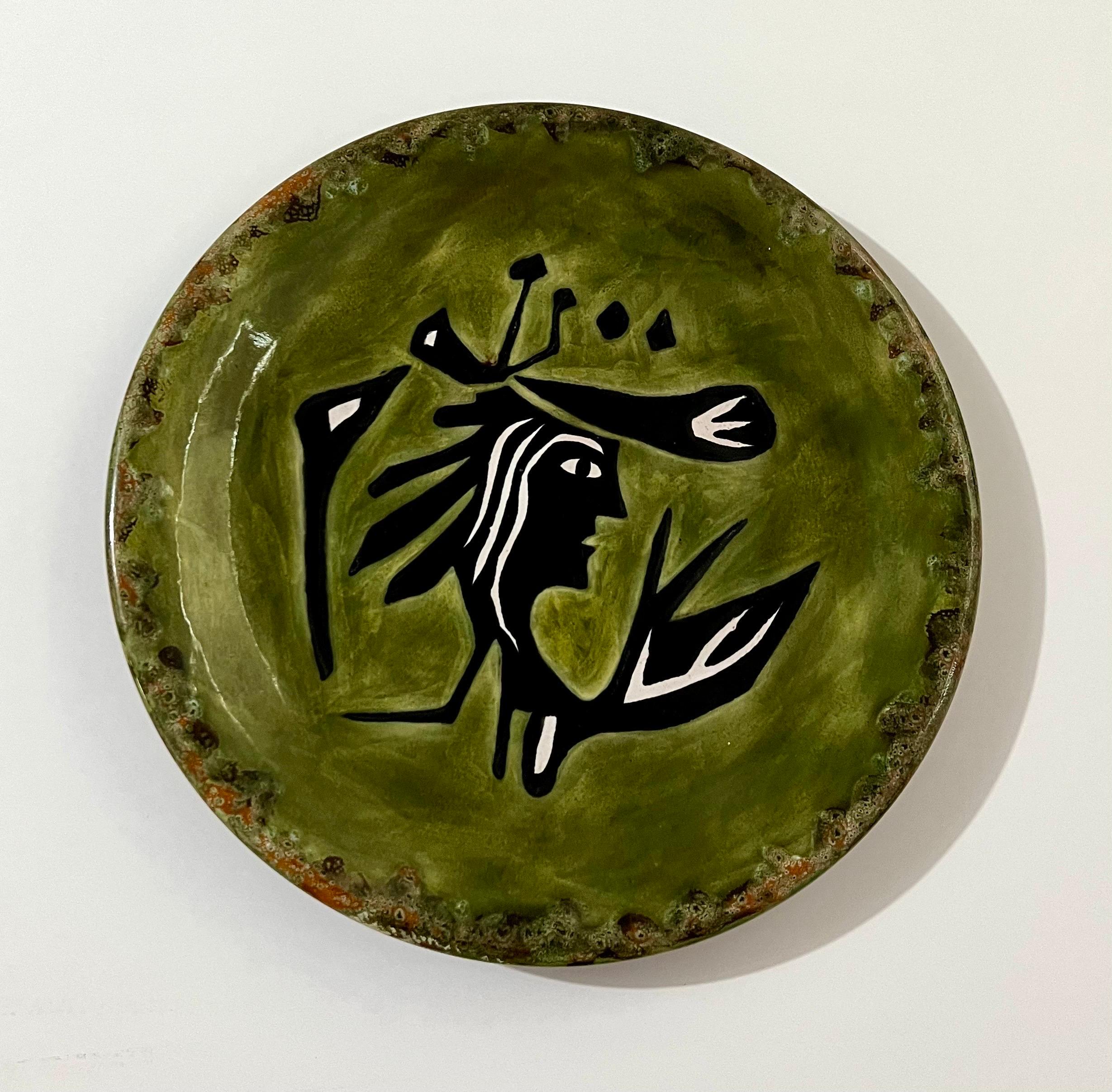 Vintage Jean Lurcat glazed fired enamel wall plaque ceramic plate limited edition hand inscribed faience Ceramique Saint Vicens charger.  It depicts a highly stylized figure of a woman in bright, vibrant moss green color.
Jean Lurçat (French: 1892 –