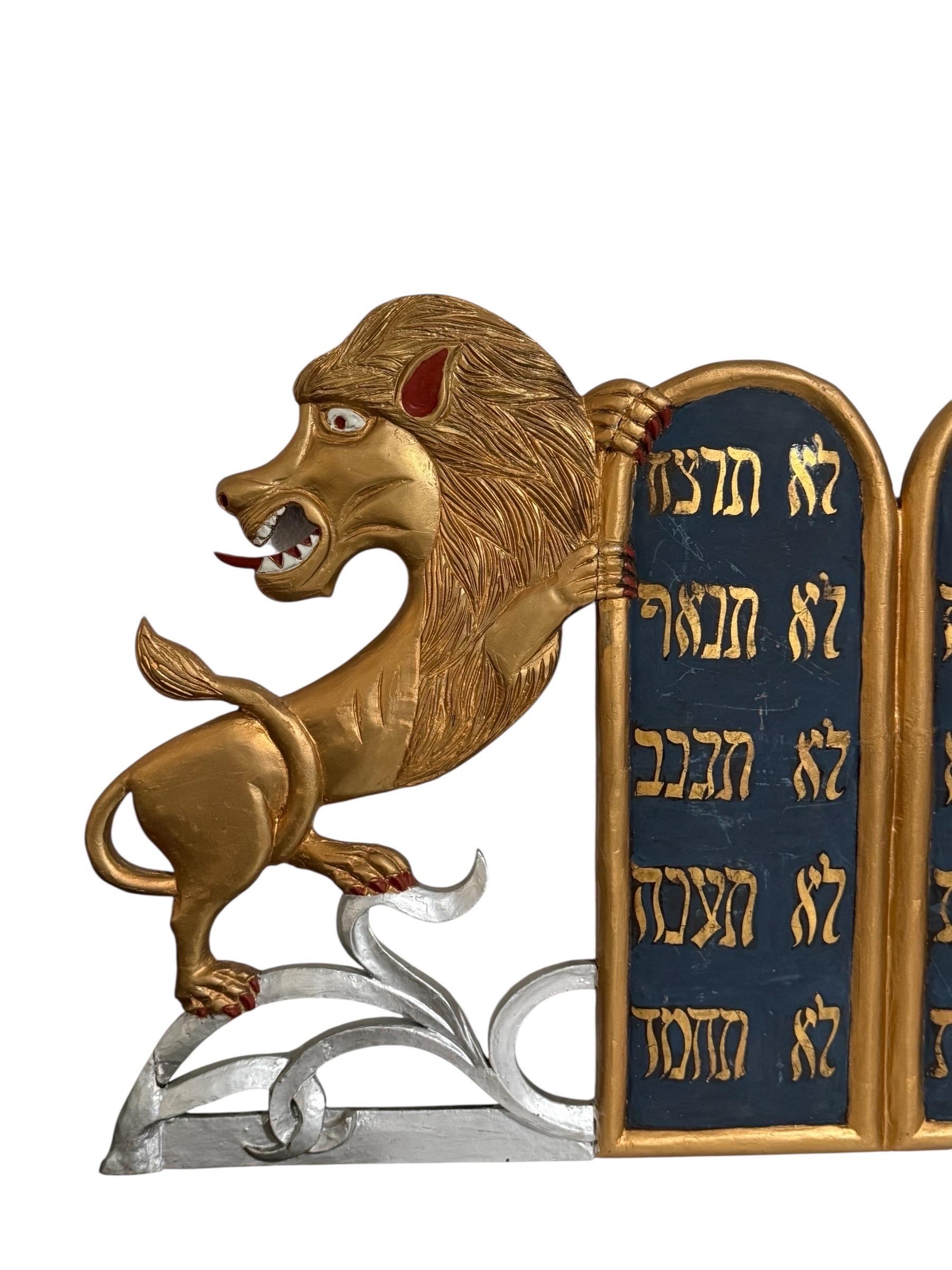 Paint and gold paint on wood
Circa early to mid 20th century.
This is not signed

A treasure from a proud congregation. It is a hand-carved wooden sculpture showing the Tablets of the Law flanked by two Lions of Judah. Their paws held the tablets.