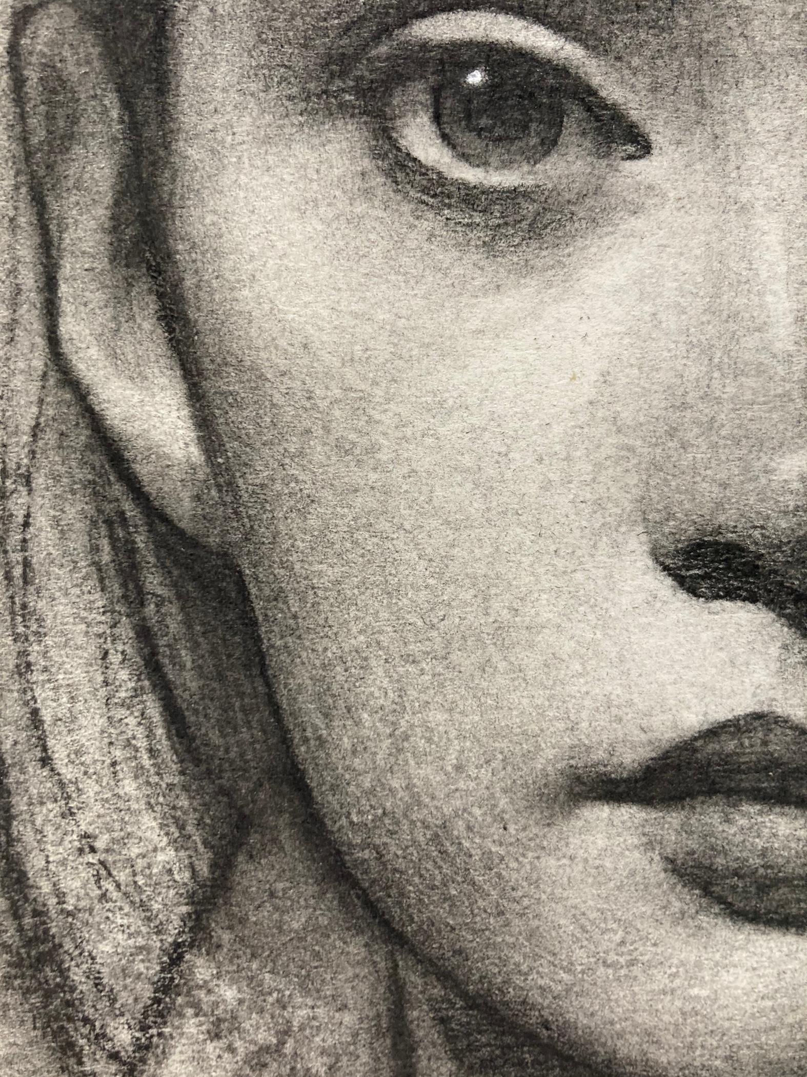 A charcoal portrait drawing of a young woman. 

