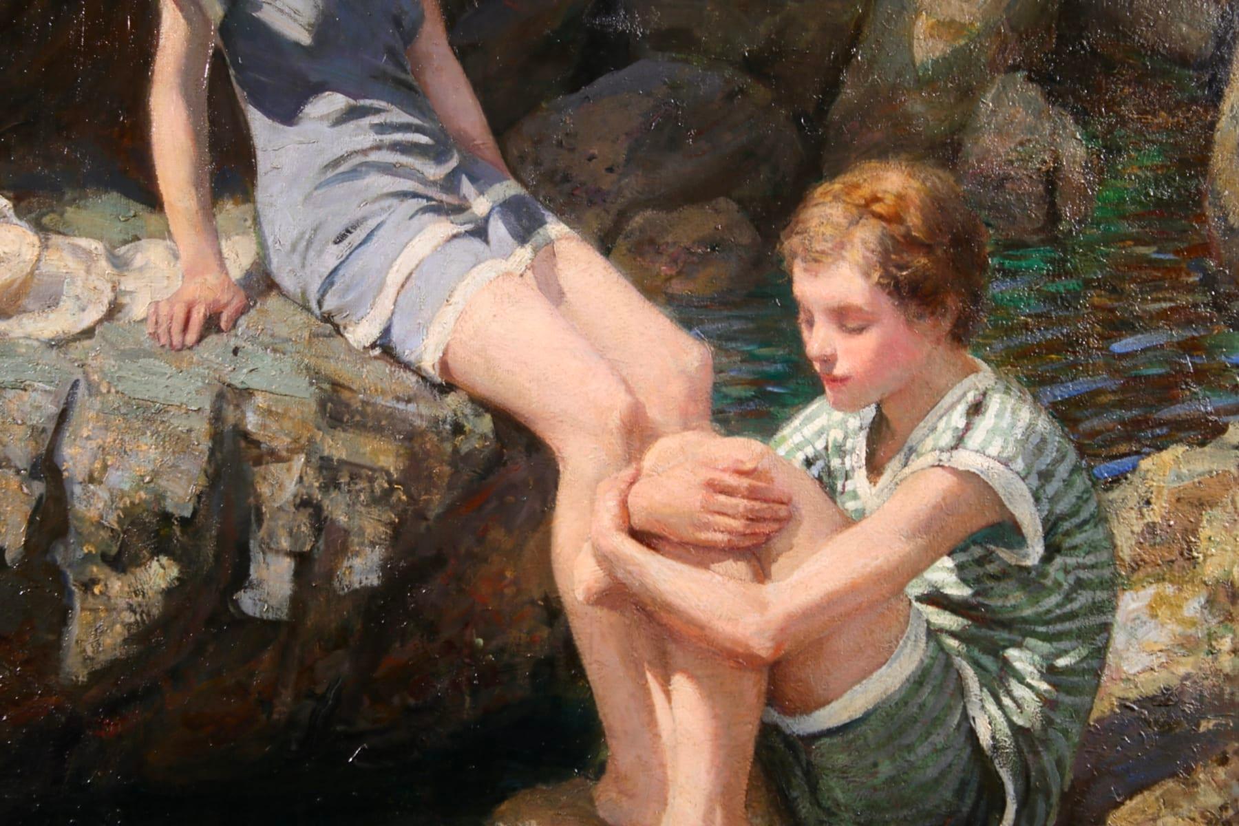 A wonderful and charming large oil on canvas circa 1920 by British painter Rowland Wheelwright. The piece depicts two girls in bathing outfits perched on rocks in the summer sun watching a school of small fish swimming in the water. A stunning piece
