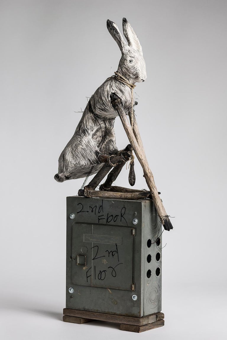 Elizabeth Jordan Figurative Sculpture - Sculpture of Rabbit sitting on electrical box, earth tone: 'Federal Pacific'