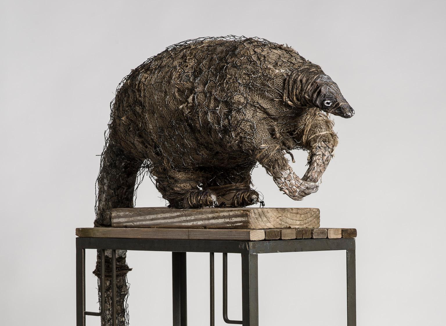Anteater sculpture on high platform with tin cans: 'A Grim Fairy Tale' - Sculpture by Elizabeth Jordan